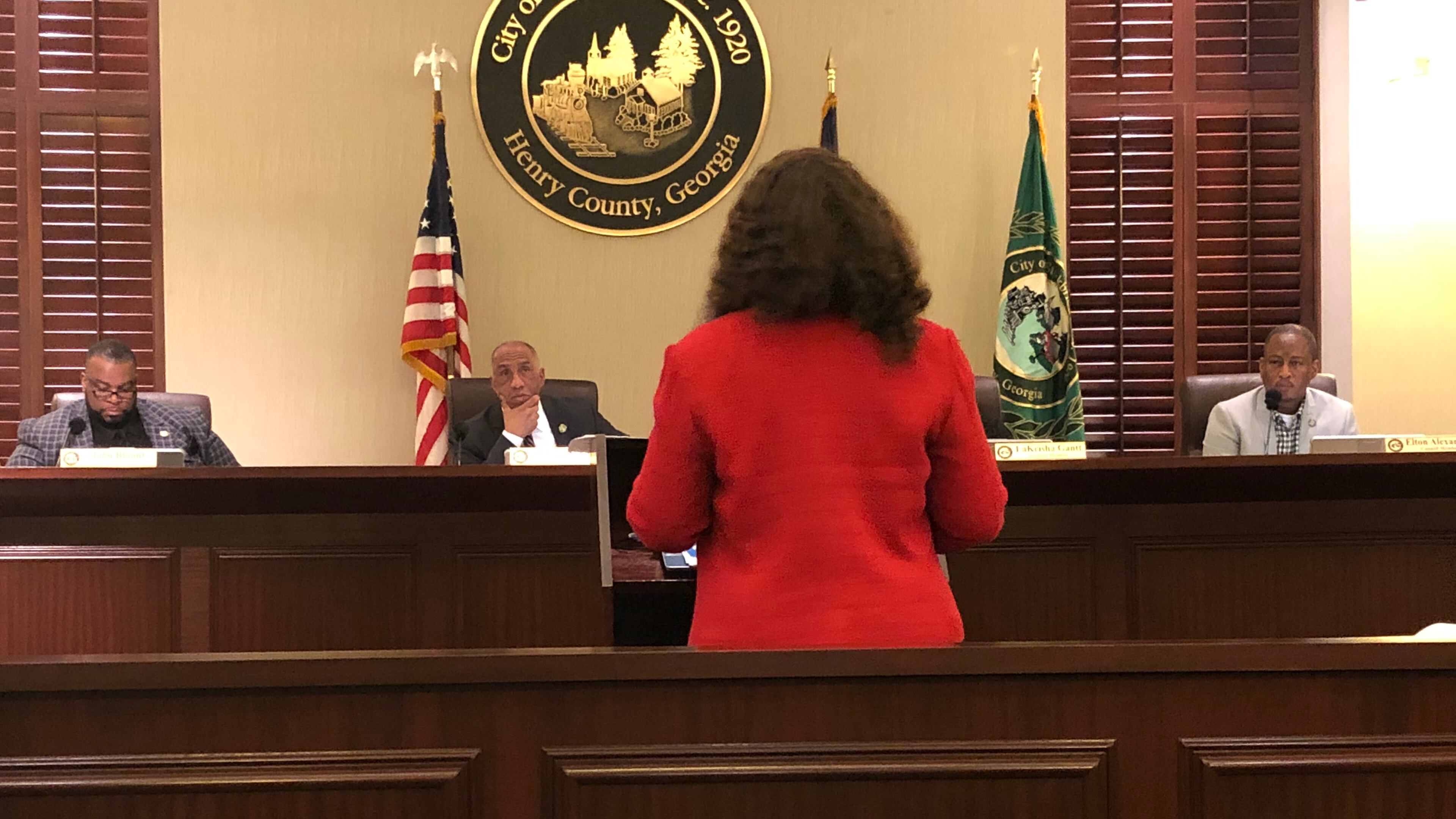 Camilla Moore, Stockbridge Community Development Director, talks to City Councilmembers about establishing impact fees on development. LEON STAFFORD/AJC