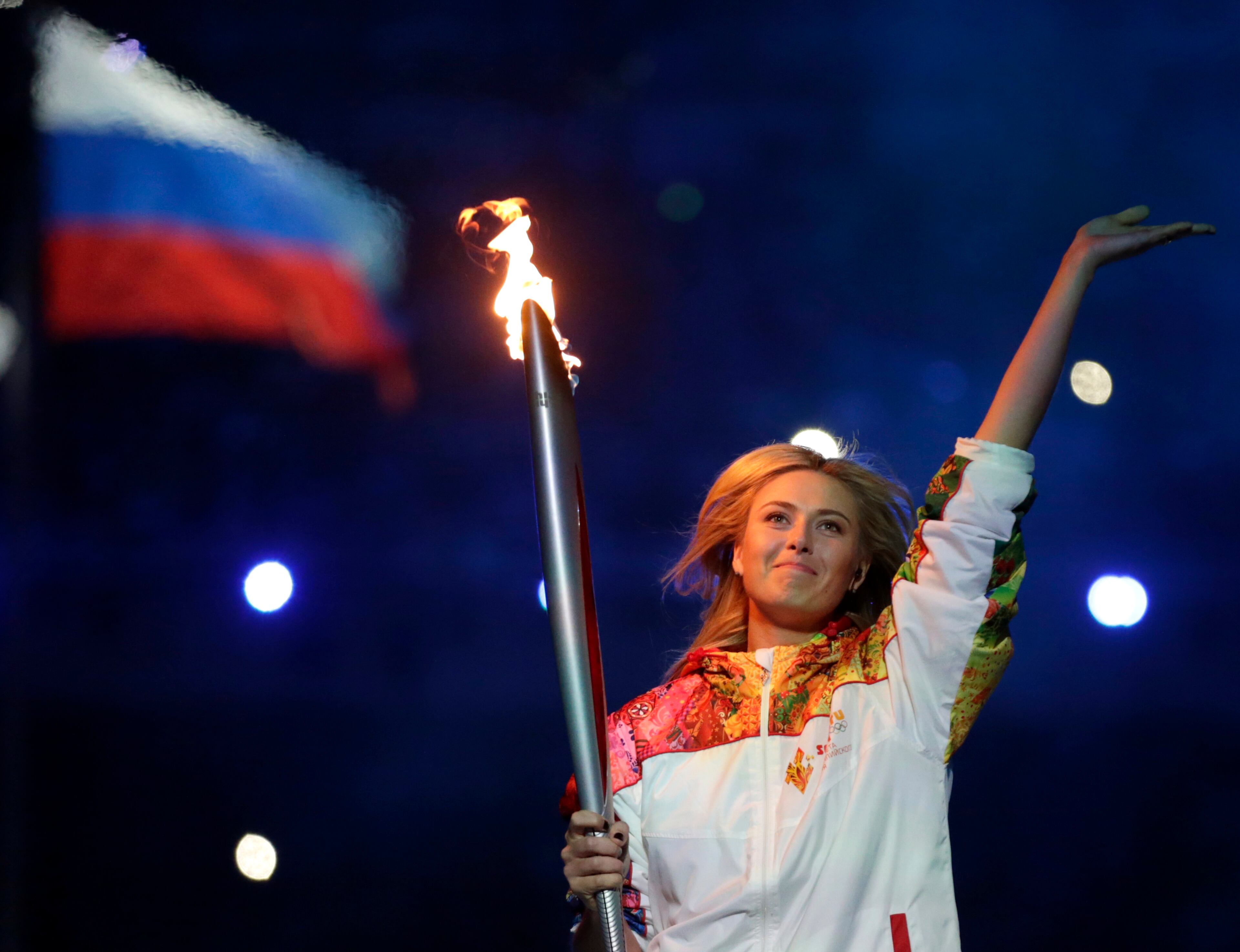 Russia's Maria Sharapova carries the torch during the opening ceremony of the 2014 Winter Olympics in Sochi, Russia, Friday, Feb. 7, 2014. (AP Photo/Matt Dunham)