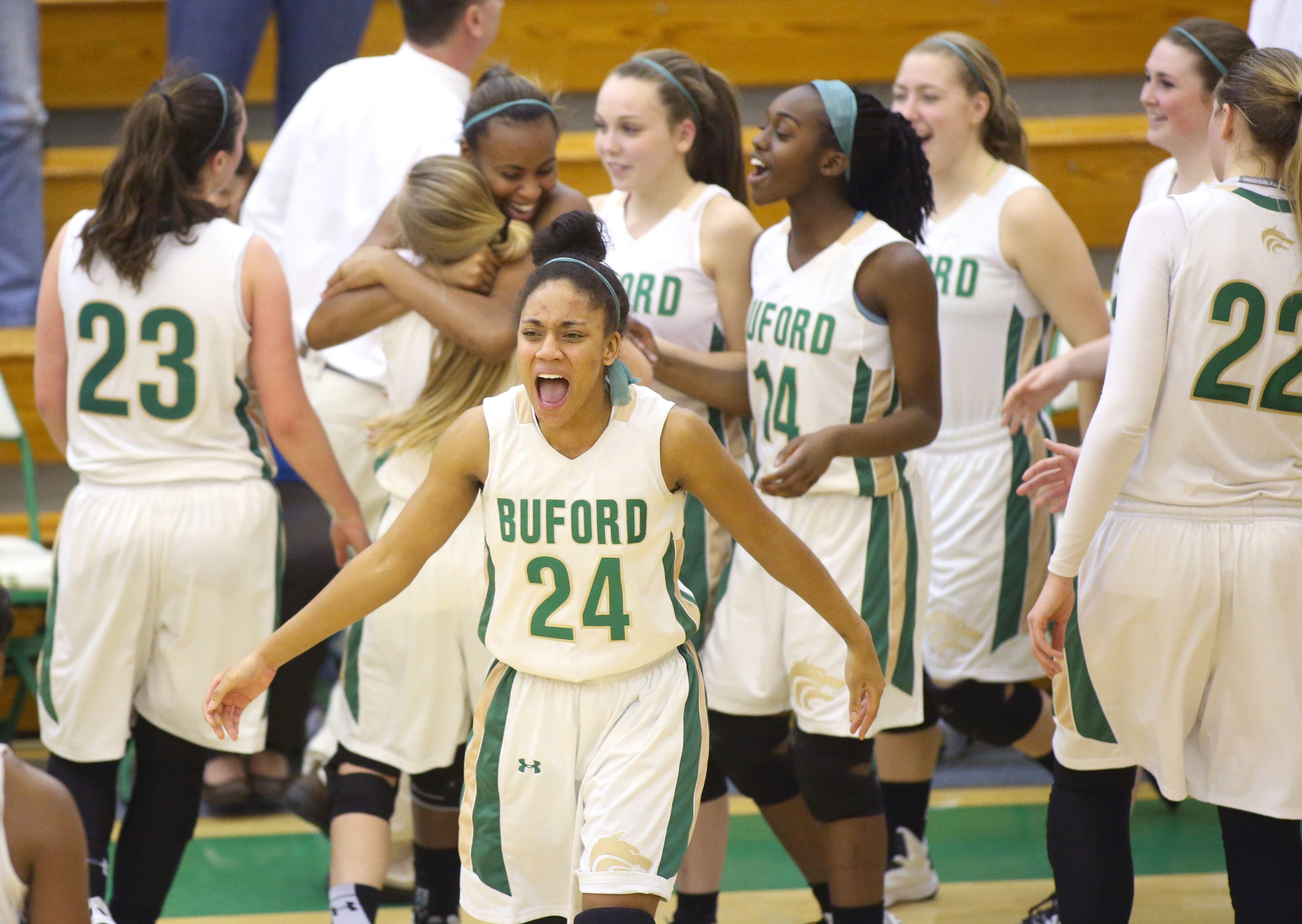 As time expires, Buford's Ashley Kroeger (24) and others celebrate their win over Decatur Monday night. Buford defeated Decatur 41-28 in the second round of the Class AAA state basketball tournament. JASON GETZ / SPECIAL