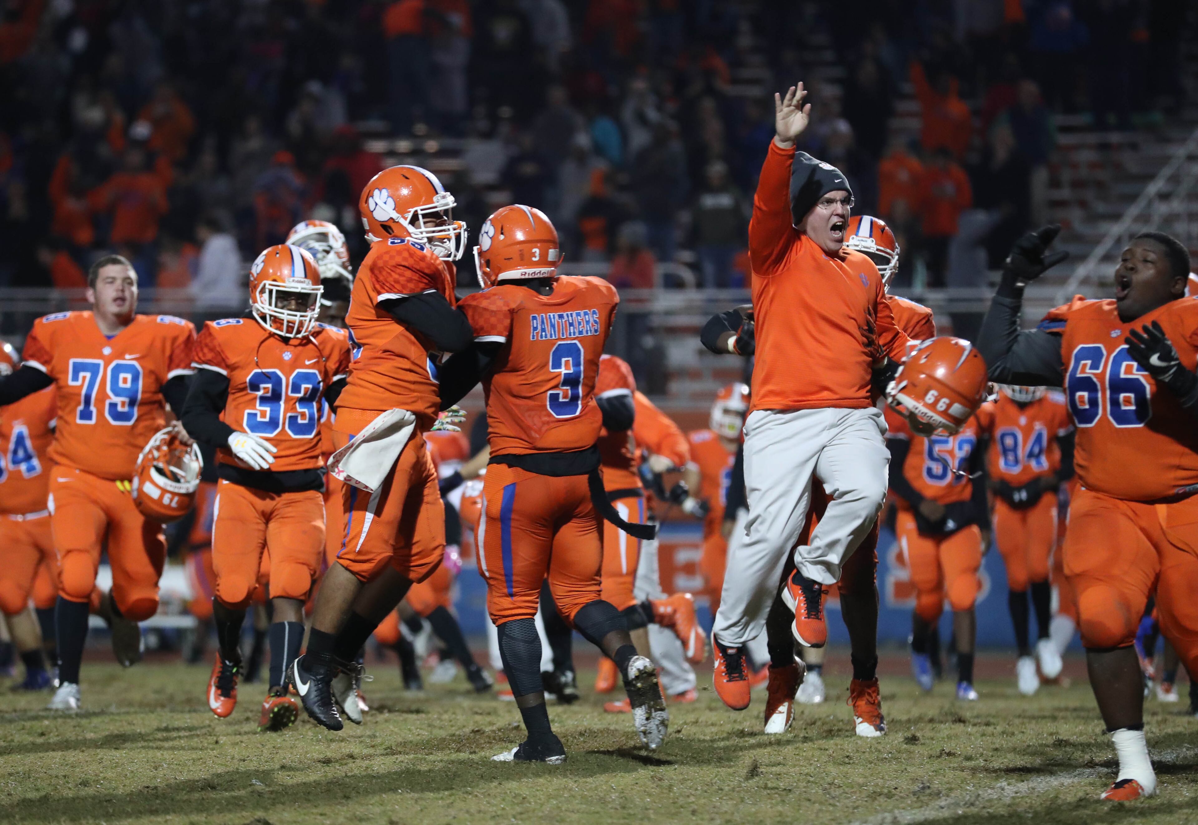 Parkview players and coaches celebrate their overtime win against Newton in the first round of the Class AAAAAAA playoffs at Parkview High School Friday, November 10, 2017, in Lilburn, Ga. Parkview won 42-35 in overtime. PHOTO / JASON GETZ