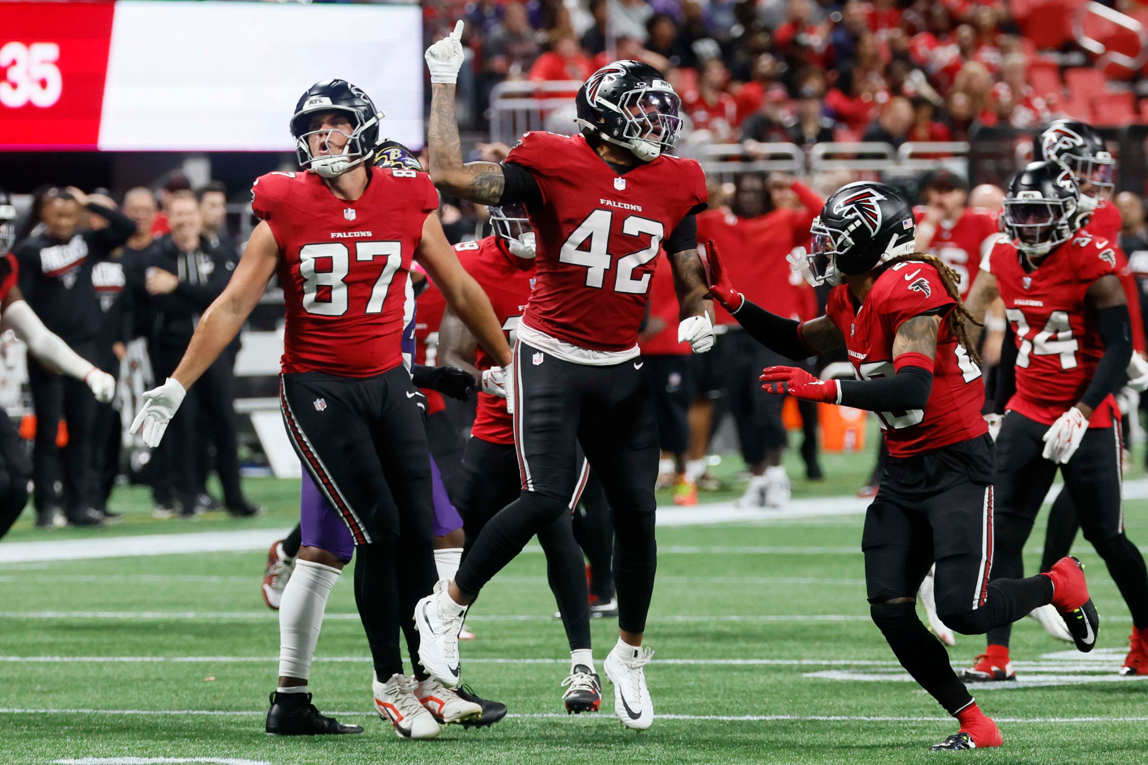 Atlanta Falcons linebacker Josh Woods (42) and tight end Nick Muse (87) react after a play in the second half of a football game against the Baltimore Ravens at Mercedes-Benz Stadium in Atlanta, GA, on Sunday, Oct. 11, 2026. (Miguel Martinez/AJC)