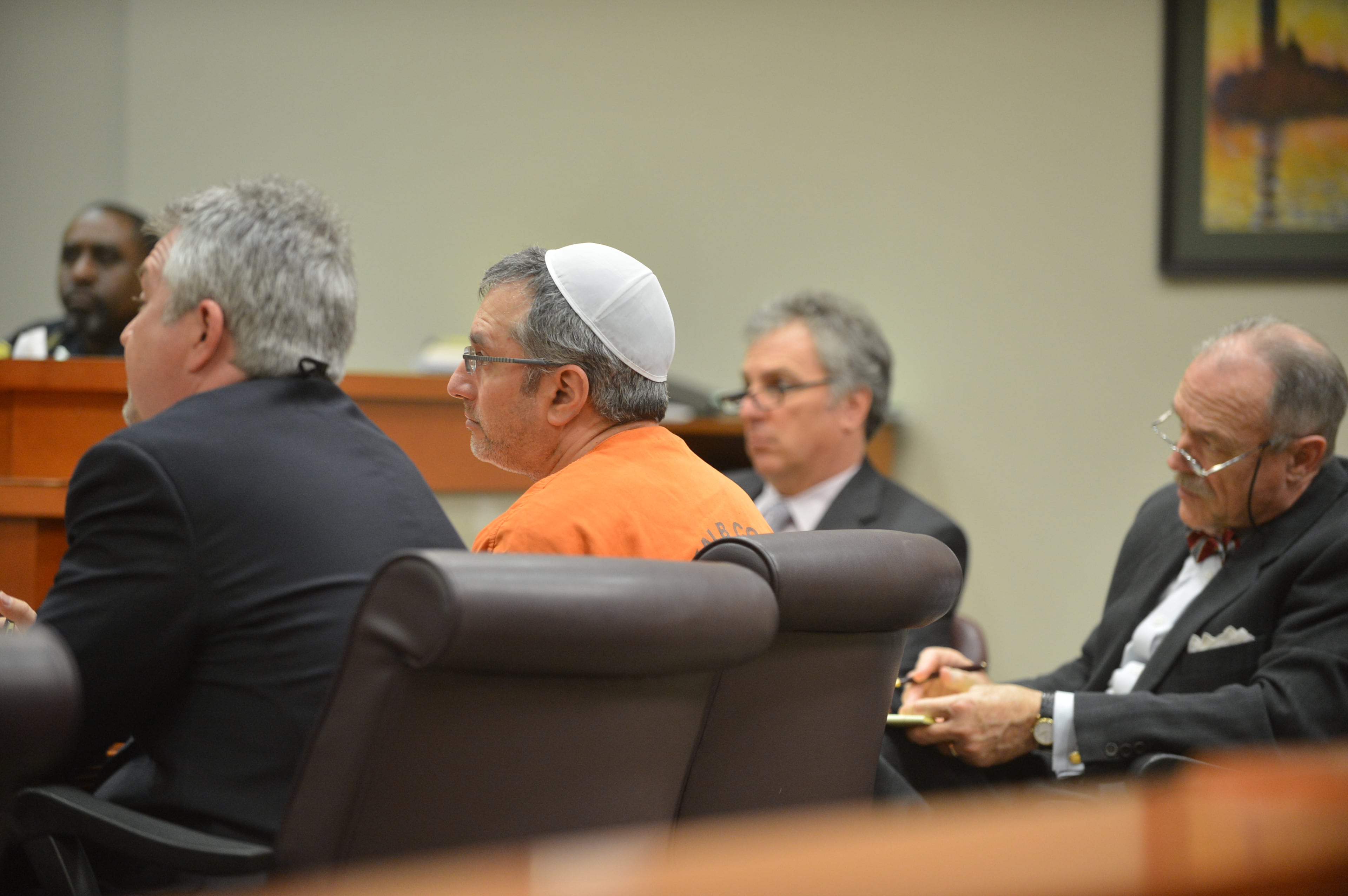 Hemy Neuman entered court shortly before 1:30 p.m. Tuesday, wearing an orange DeKalb County jumpsuit. He sat at the defense table with his attorneys, Doug Peters and Bob Rubin. DeKalb Superior Court Judge Gregory A. Adams presided.