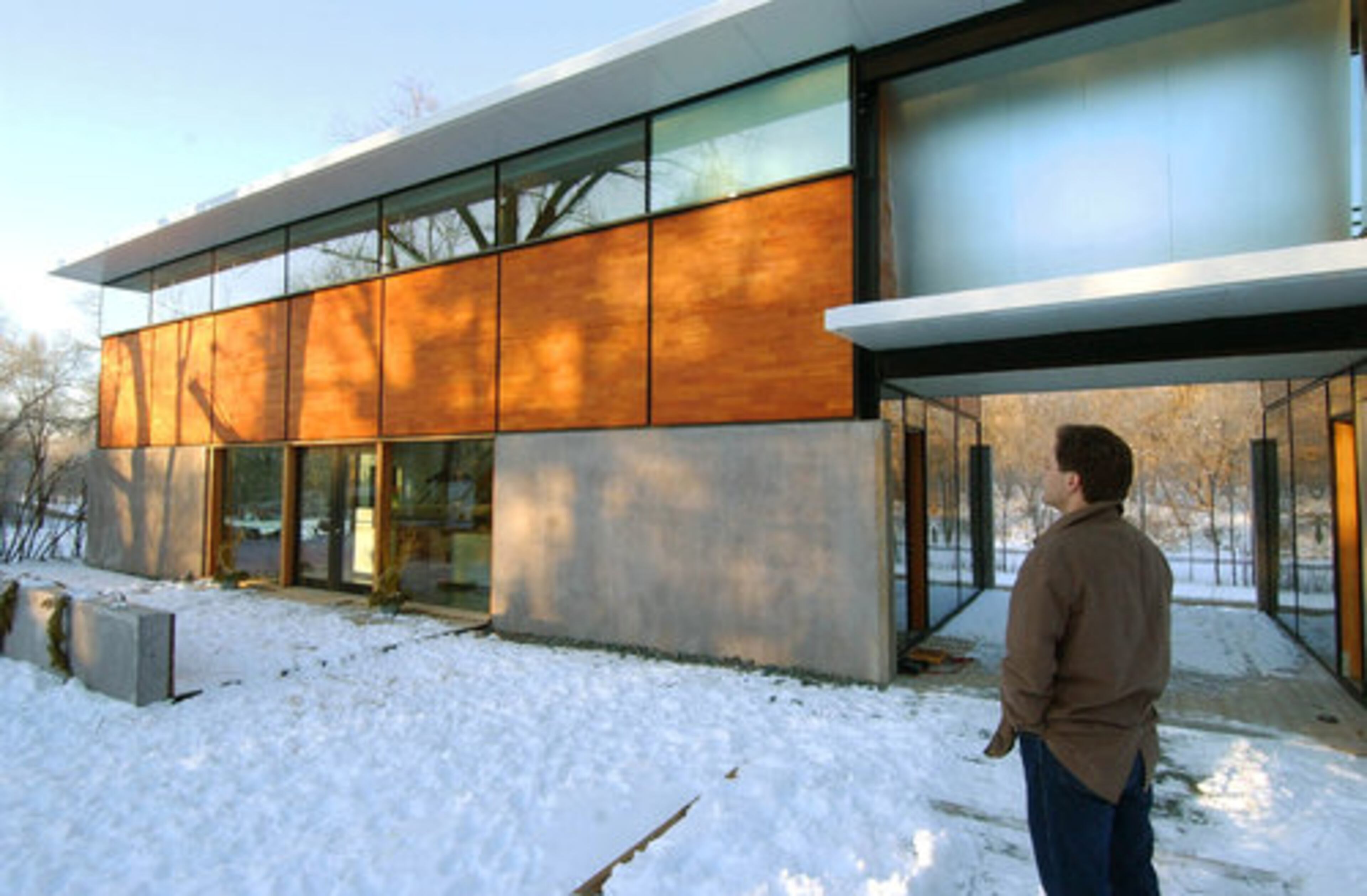 Builder Charlie Lazor is shown outside the manufactured home he built in south Minneapolis. The home transports in flat panels, leading to it's name, Flatpakhouse.