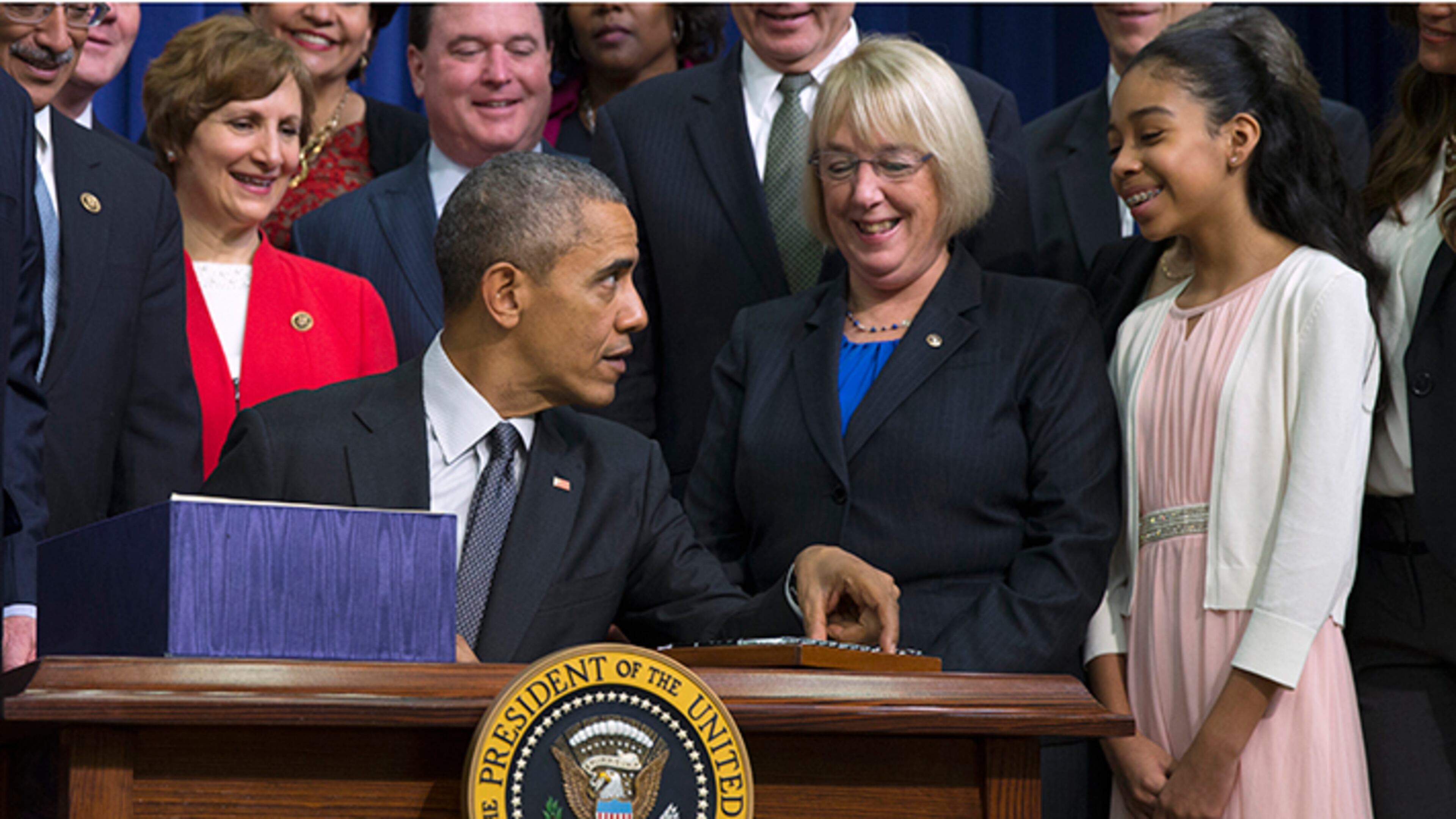 President Barack Obama talks with student Sofia Rios, of Arlington, Va., right, as he signs the "Every Student Succeeds Act" on Dec. 8, 2015.