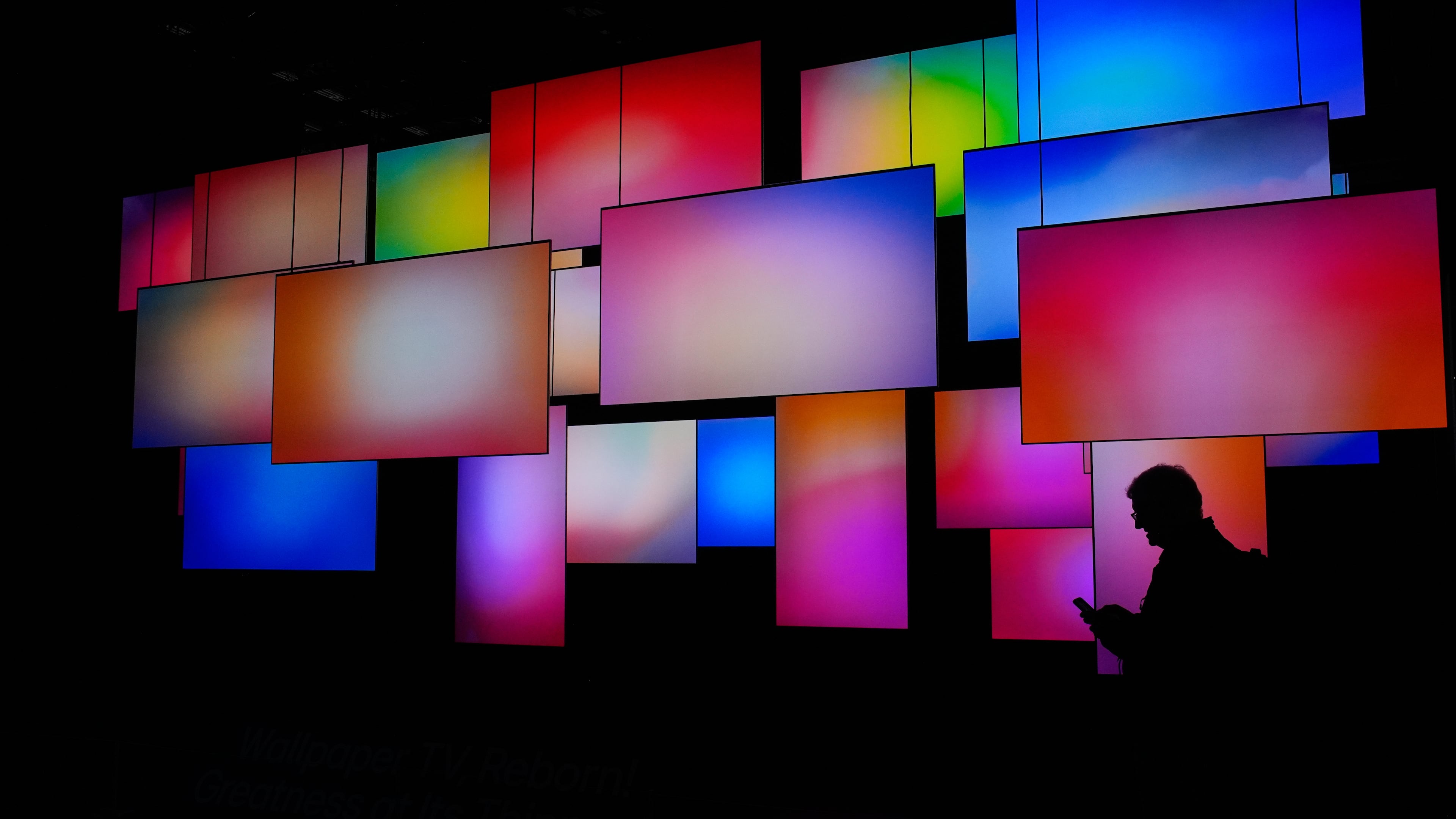 A Person walks past a wallpaper TV display at the LG booth during the CES tech show Wednesday, Jan. 7, 2026, in Las Vegas. (AP Photo/John Locher)