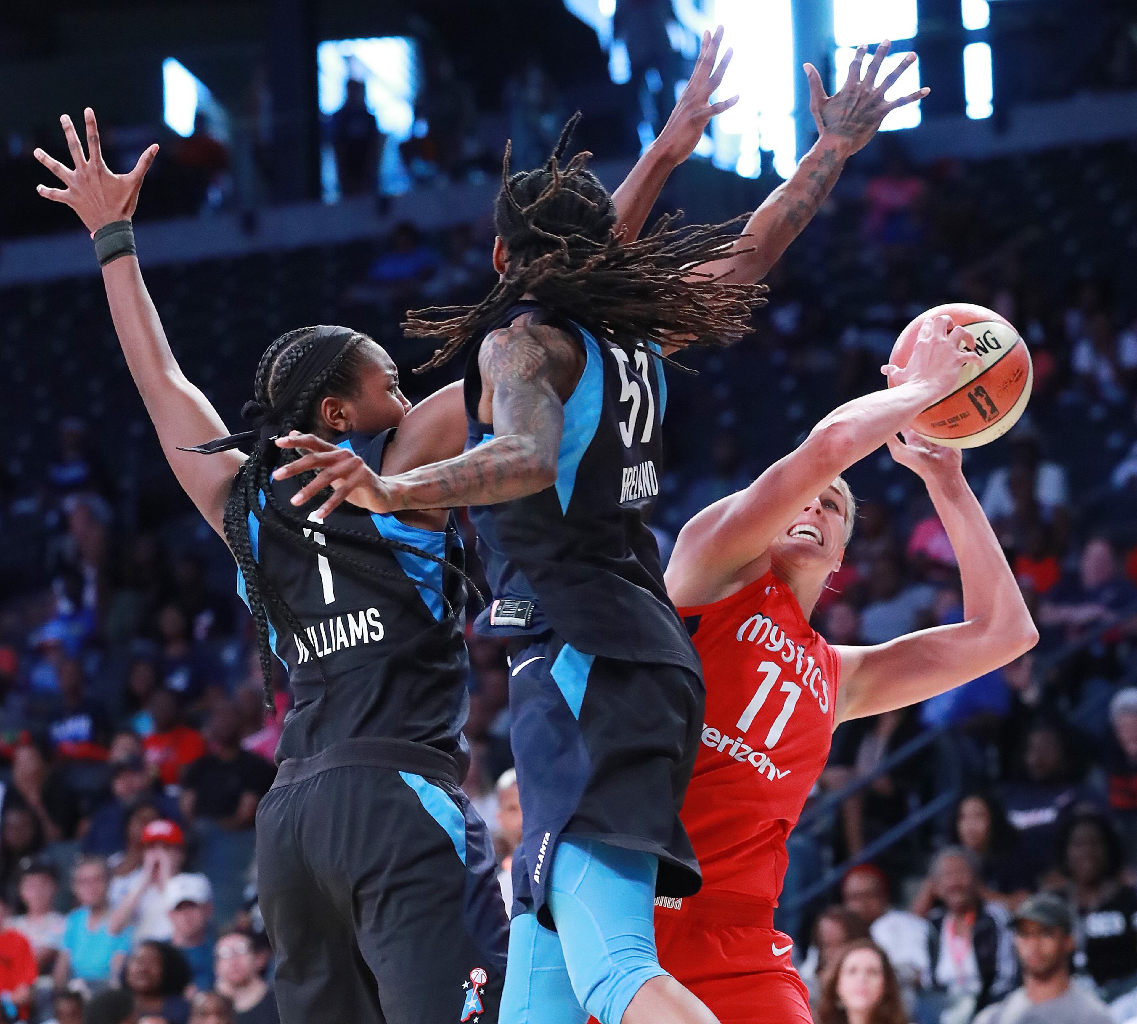 August 26, 2018 Atlanta: Washington Mystics forward Elena Delle Donne, who led the team with 32-points, gets off a shot around Atlanta Dream defenders Elizabeth Williams and Jessica Breland during the second half in a WNBA semifinal playoff game on Sunday, August 26, 2018, in Atlanta. The Mystics beat the Dream 87-84. Curtis Compton/ccompton@ajc.com