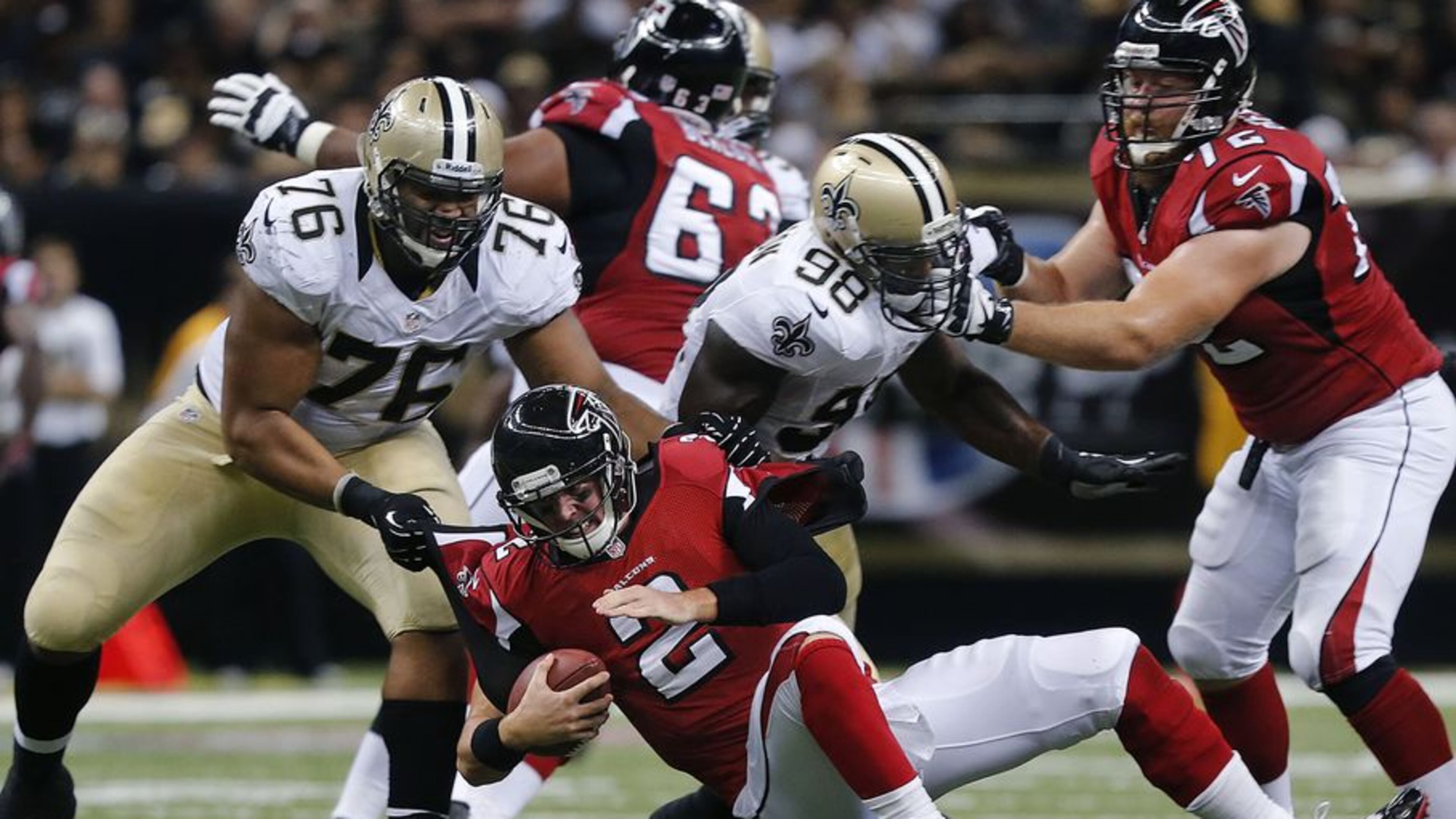 Matt Ryan is sacked by Akiem Hicks, one of three New Orleans sacks in last season's opener at the Superdome. (Bill Haber / Associated Press)