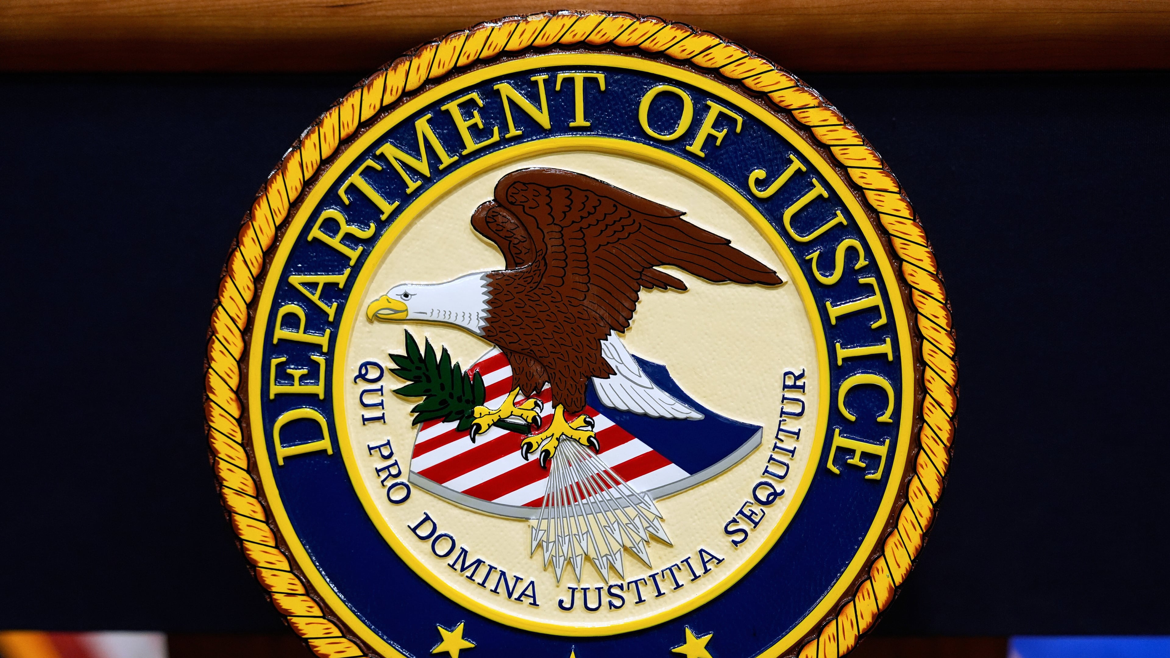FILE - The U.S. Department of Justice logo is seen on a podium before a news conference at the Justice Department in Washington, on May 6, 2025. (AP Photo/Julia Demaree Nikhinson, File)