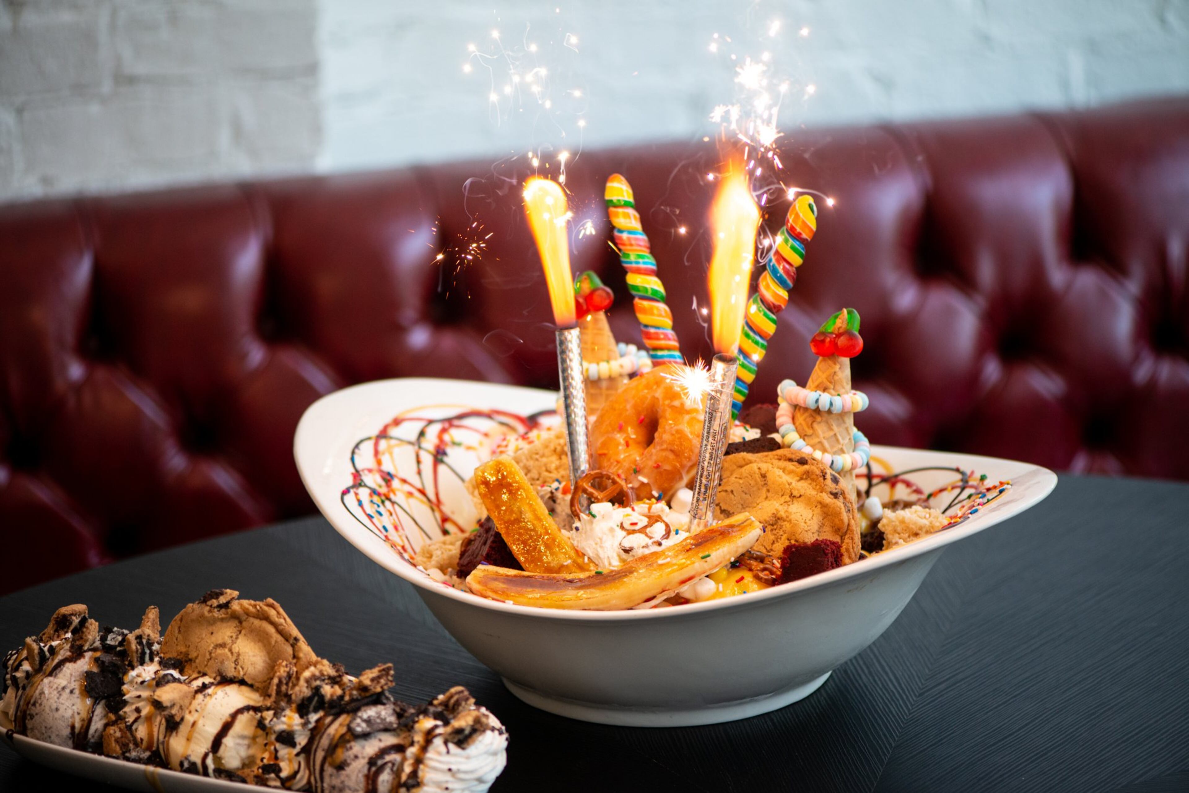 The Sugar Factory World Famous Sugar Factory King Kong Sundae $99 serves 12 with 24 scoops of ice cream covered in cookies, a doughnut, a cupcake, and candy, topped with whipped cream and sparklers. Photo credit: Mia Yakel.