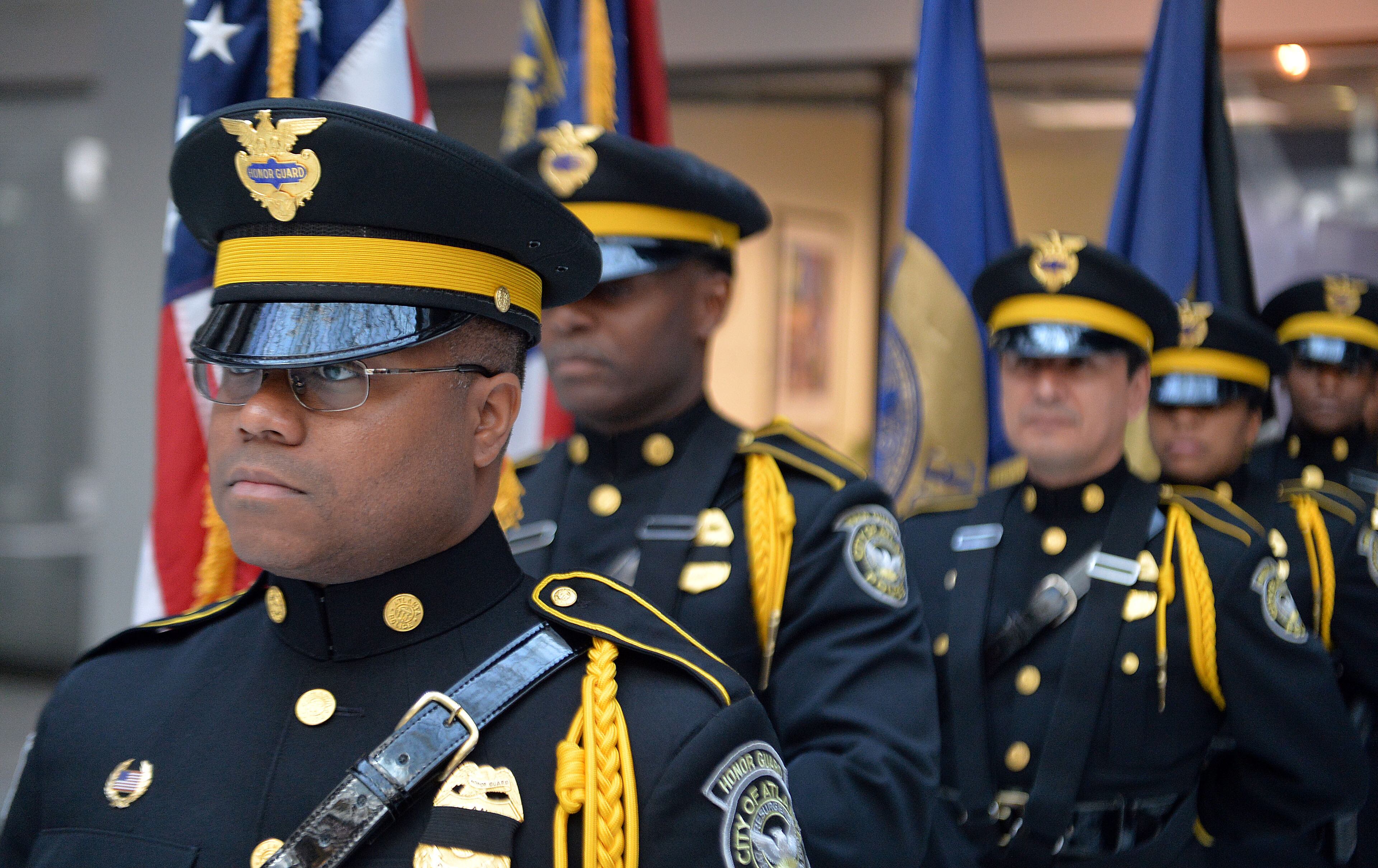 Officer Dwayne Hilton and other members of the Atlanta Police Department Honor Guard await the start of the service. The Atlanta Police Department recognized 82 fallen officers during the 24th Annual Police Memorial Service at the Atlanta City Hall atrium, Tuesday, May 5, 2015. KENT D. JOHNSON /KDJOHNSON@AJC.COM