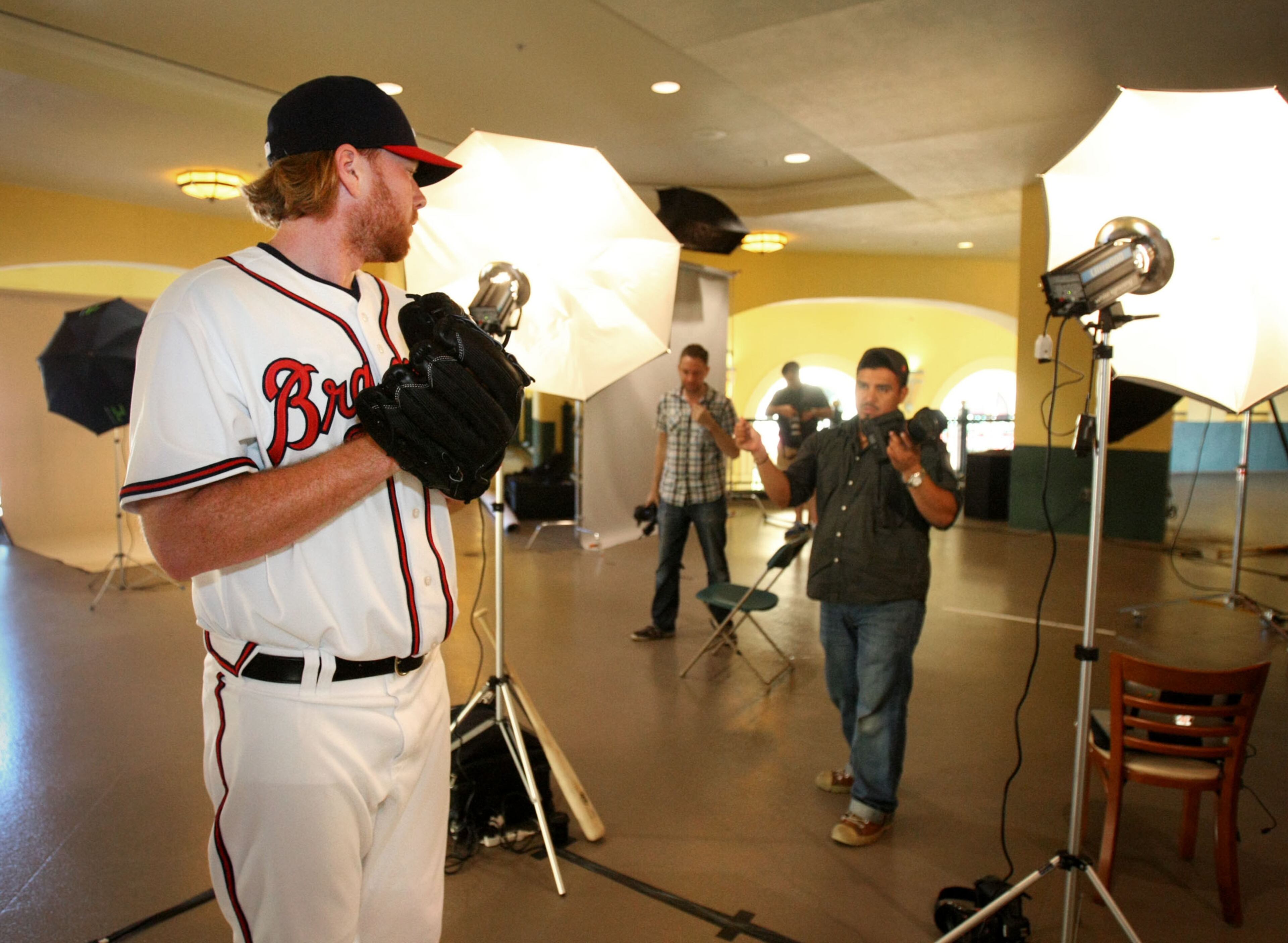 Atlanta Braves pitcher Tommy Hanson poses for photographer Julio Cortez, right, during the team's photo day at Champion Stadium in the ESPN Wide World of Sports Complex in Lake Buena Vista, Fl., on Feb. 29, 2012. Jason Getz jgetz@ajc.com