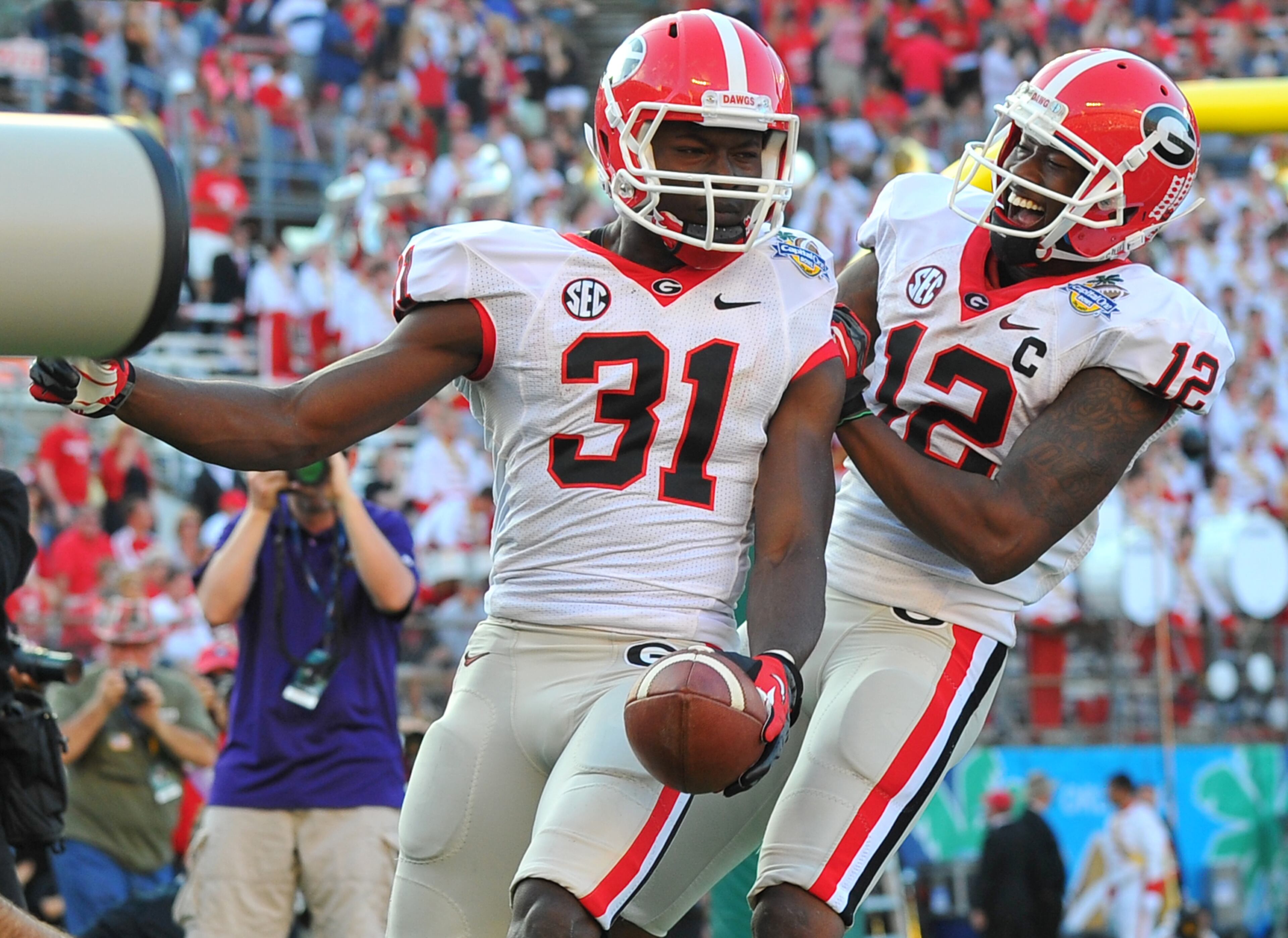 Georgia Bulldogs wide receiver Chris Conley, left, and Tavares King celebrate Conley's 87 yard reception to put the Bulldogs up 45-31 Capital One Bowl in Orlando Tuesday January 1, 2013. BRANT SANDERLIN / BSANDERLIN@AJC.COM