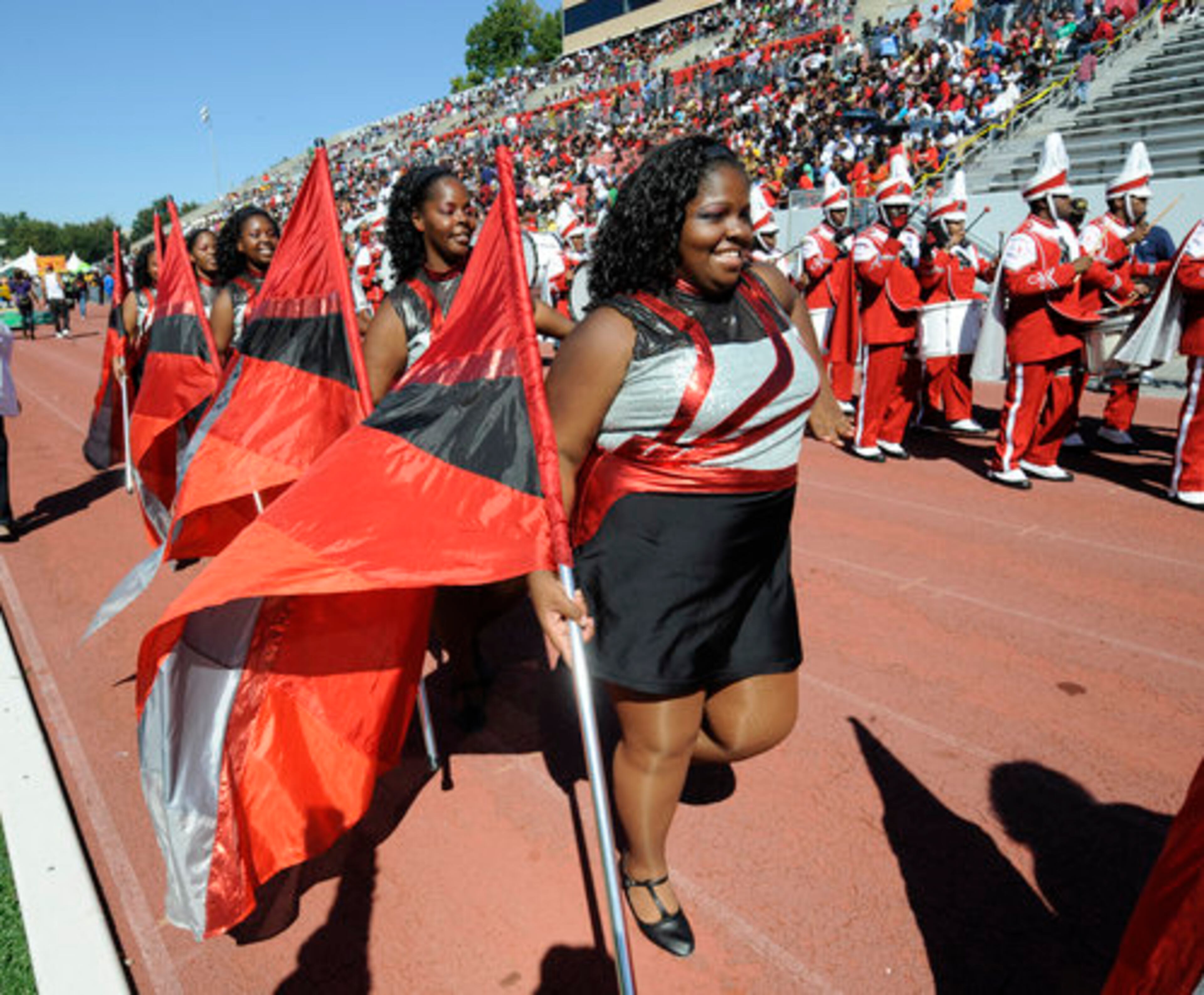 Members of the band smile as they prepare for their halftime performance.
