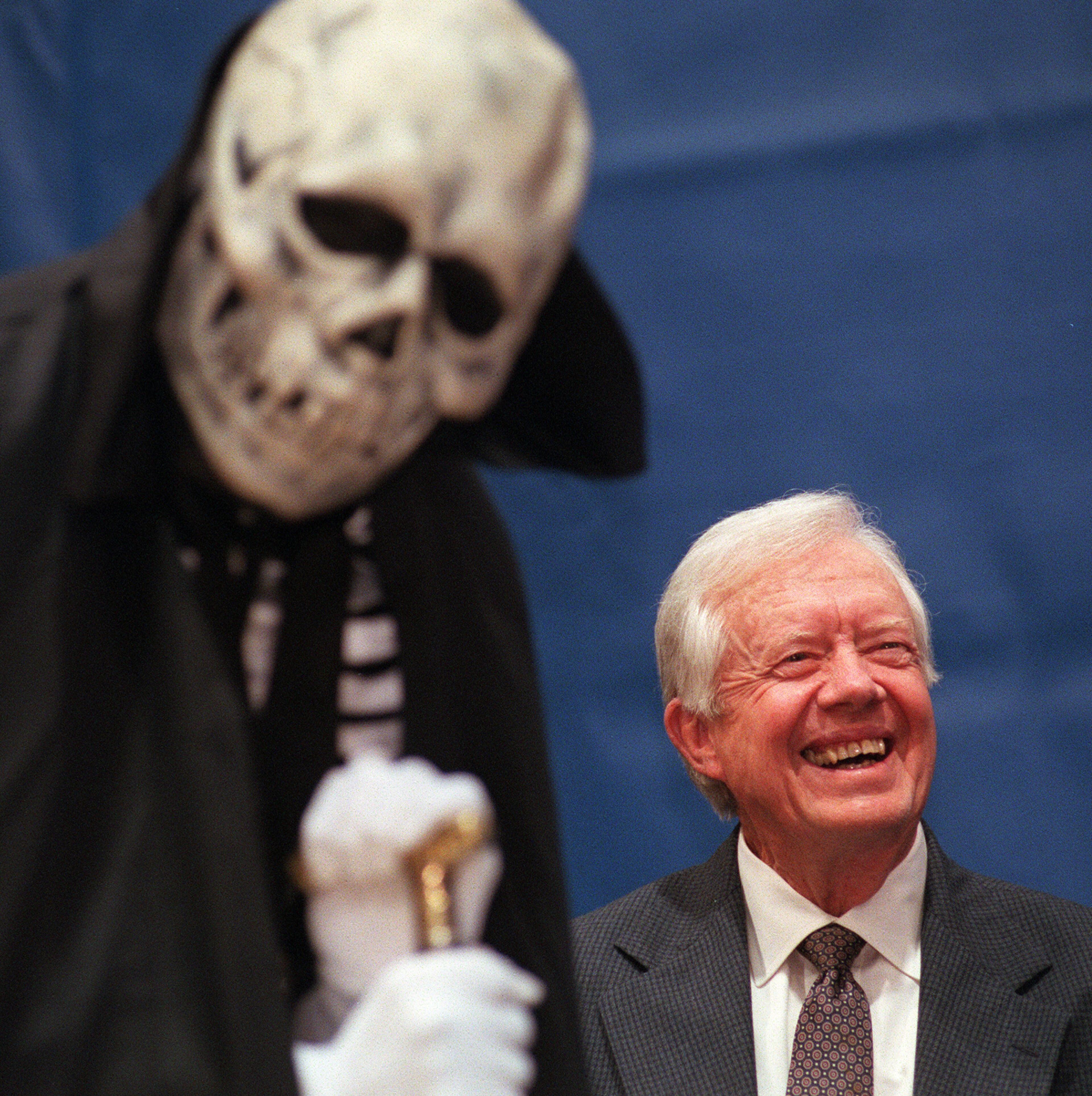 Former President Jimmy Carter laughs while listening to a greeting from Lord William M. Dooley 'The Spirit of Emory' prior to the 1999 town hall meeting with students and faculty at Emory University on Thursday evening. (BEN GRAY/STAFF)