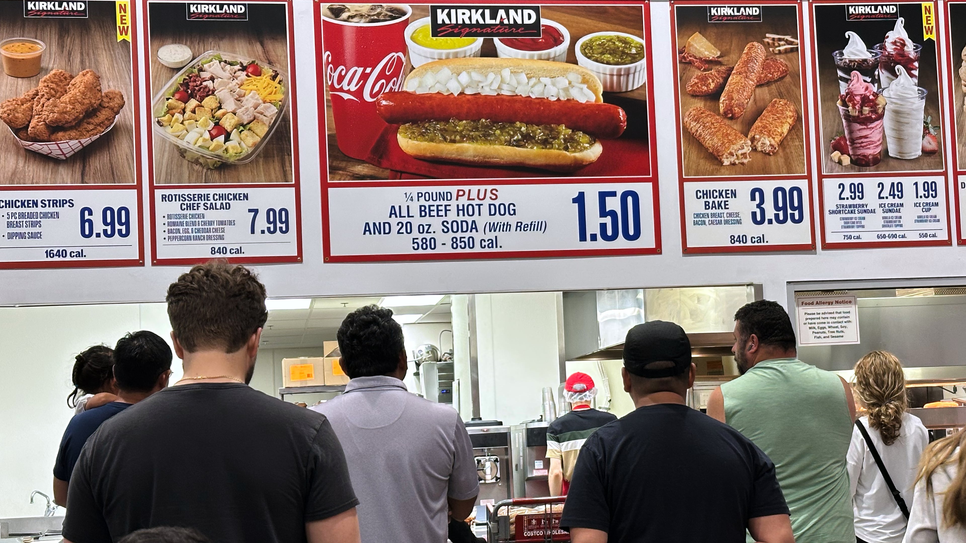 Customers wait their order in a food court at a wholesale store in Mount Prospect, Ill., Monday, June 8, 2026. (AP Photo/Nam Y. Huh)