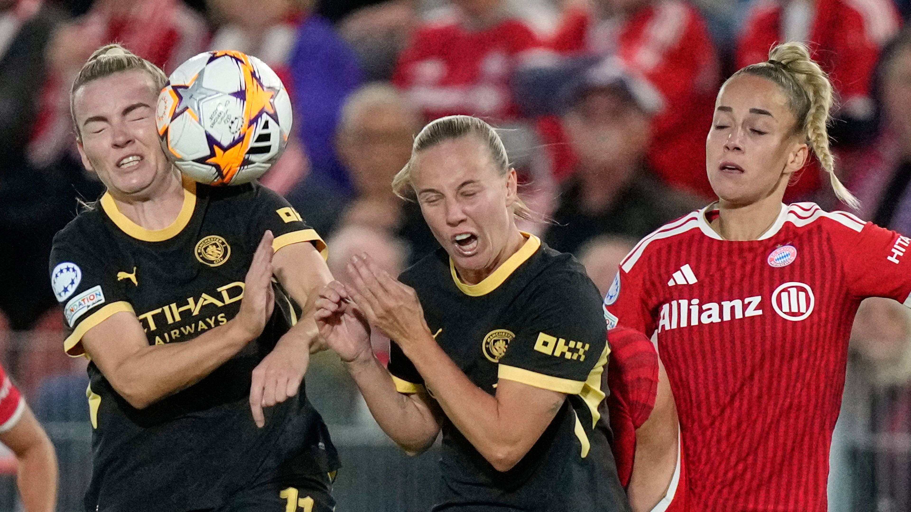 Bayern's Giulia Gwinn, right, collides with Manchester City's Beth Mead and Lauren Hemp, left, during the women's Champions League opening phase soccer match between FC Bayern Munich and Manchester City in Munich, Germany, Tuesday, Sept. 22, 2026. (AP Photo/Matthias Schrader)