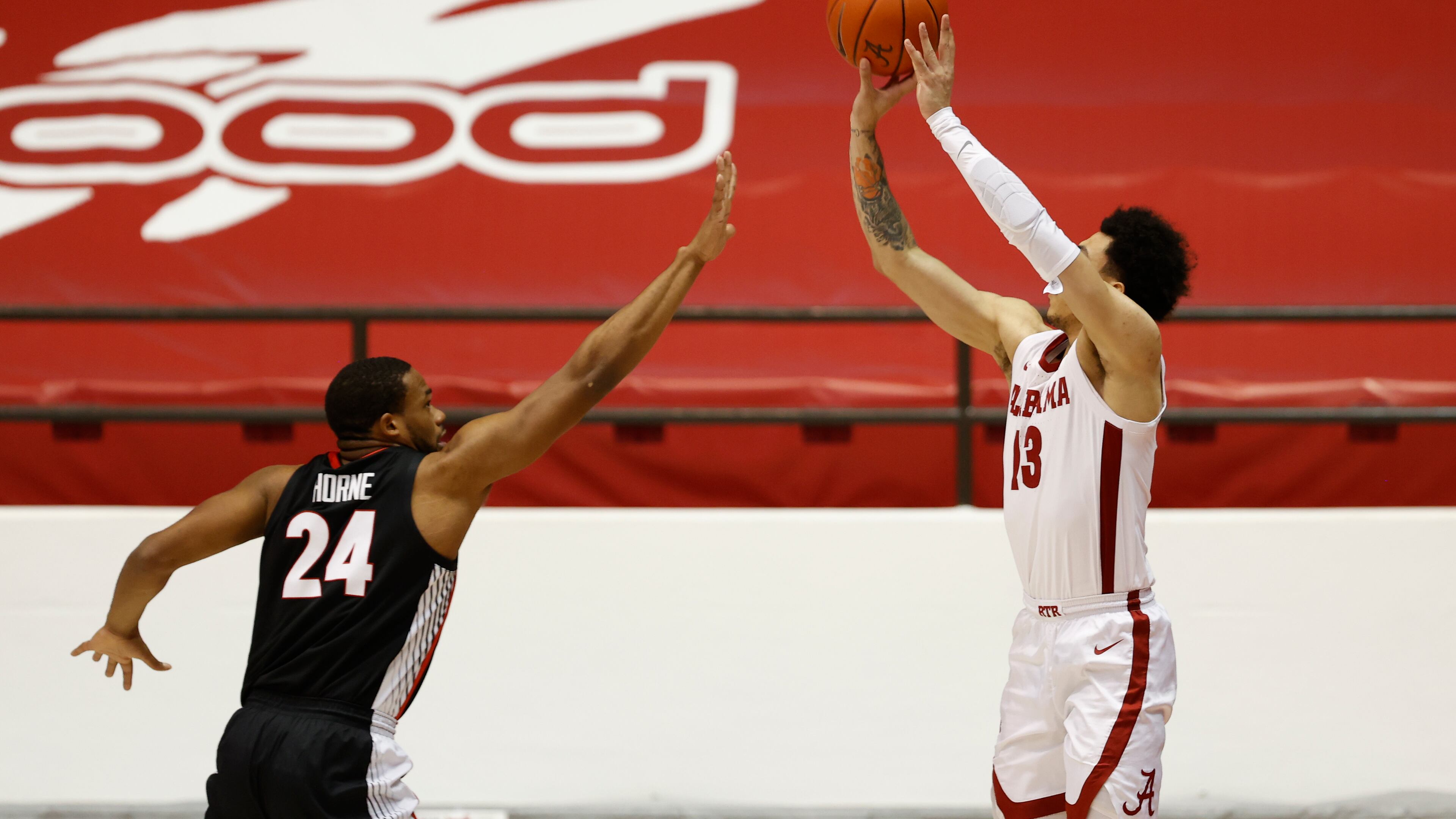 Georgia's P.J. Horne (24), here defending Alabama's Jahvon Quinerly, and the Bulldogs played poor perimeter defense in a 33-point loss to the Crimson Tide this past Saturday in Tuscaloosa. (Photo from UA Athletics)
Photo by Crimson Tide Photos