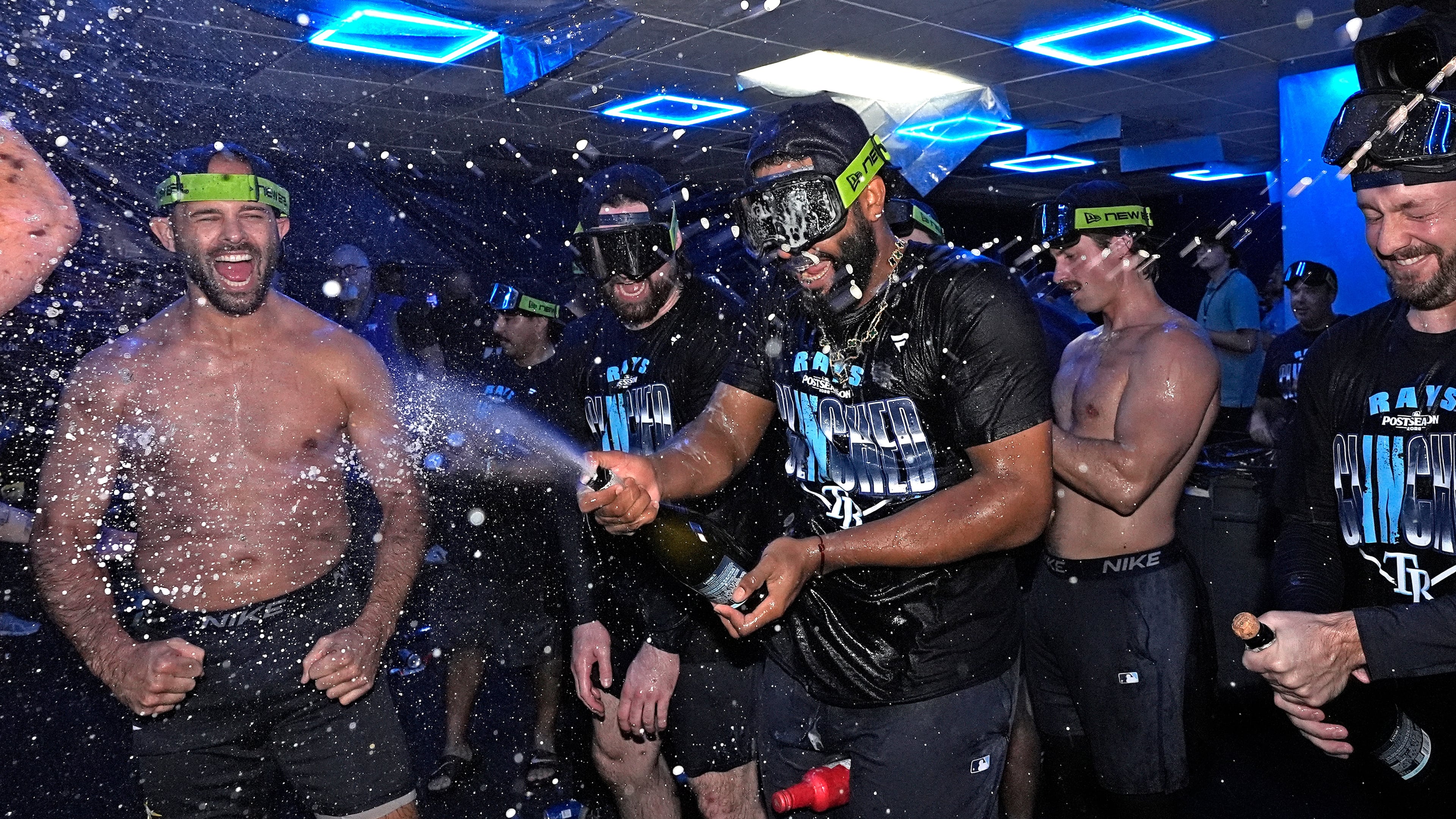 Tampa Bay Rays' Junior Caminero spreays champagne on teammates after the team clinched a playoff spot with a win over the Houston Astros during a baseball game Friday, Sept. 11, 2026, in St. Petersburg, Fla. (AP Photo/Chris O'Meara)