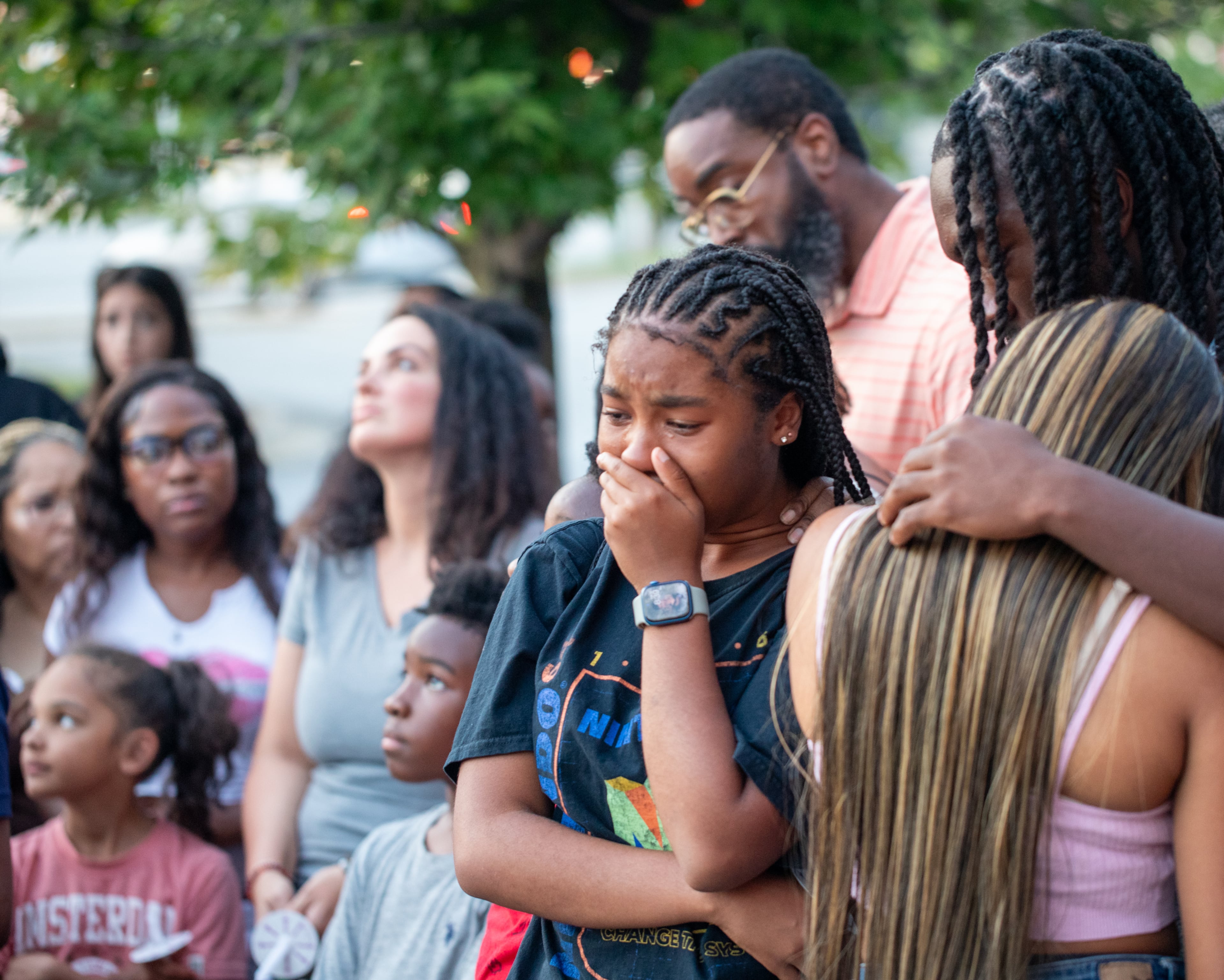 Family and friends of Jacob Johnson, including his sister Shani Johnson, 17, mourn the death of the 16-year-old at a candlelight vigil and balloon release Tuesday, July 25, 2023 at the IHOP.