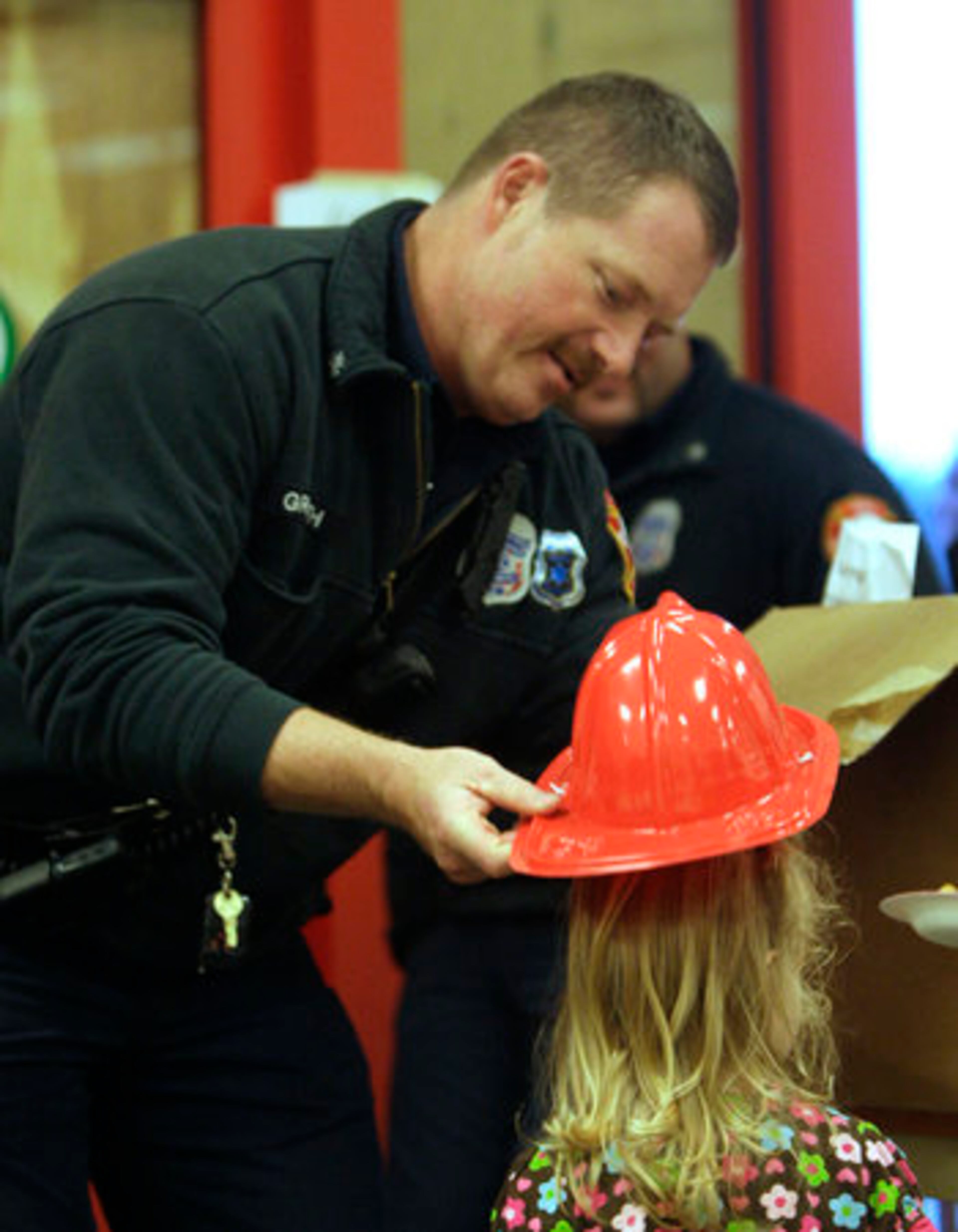 Sandy Springs firefighter Parker Griffith gave fire hats to the kids.
