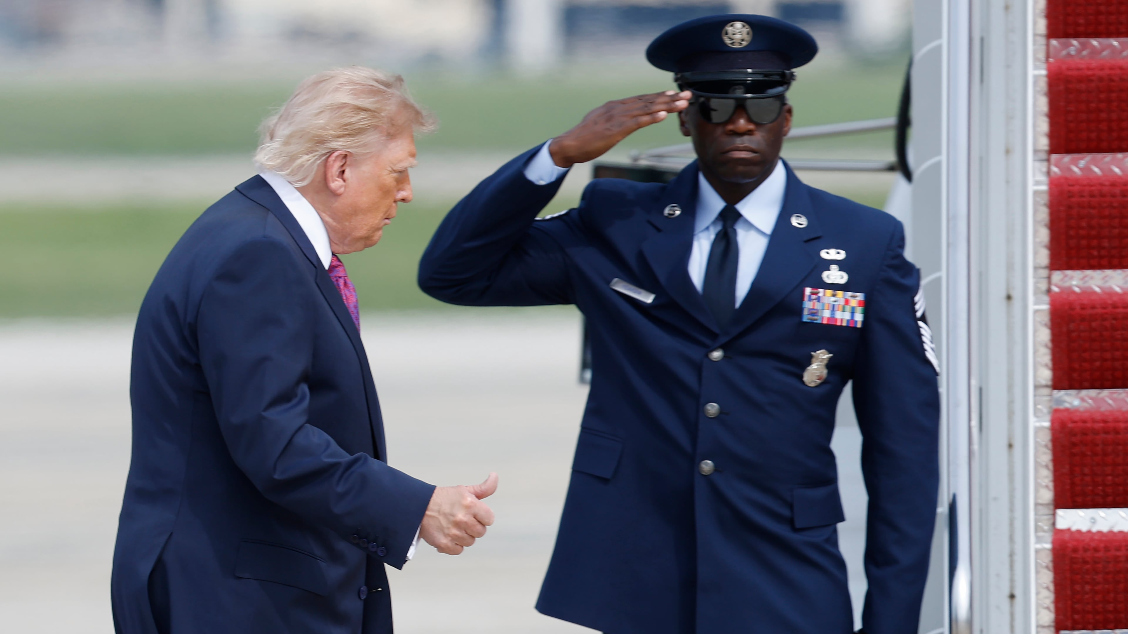 President Donald Trump, left, gestures as he walks from Marine One to board Air Force One, during his departure at Joint Base Andrews, Md., Thursday, August. 27, 2026. (AP Photo/Luis M. Alvarez)