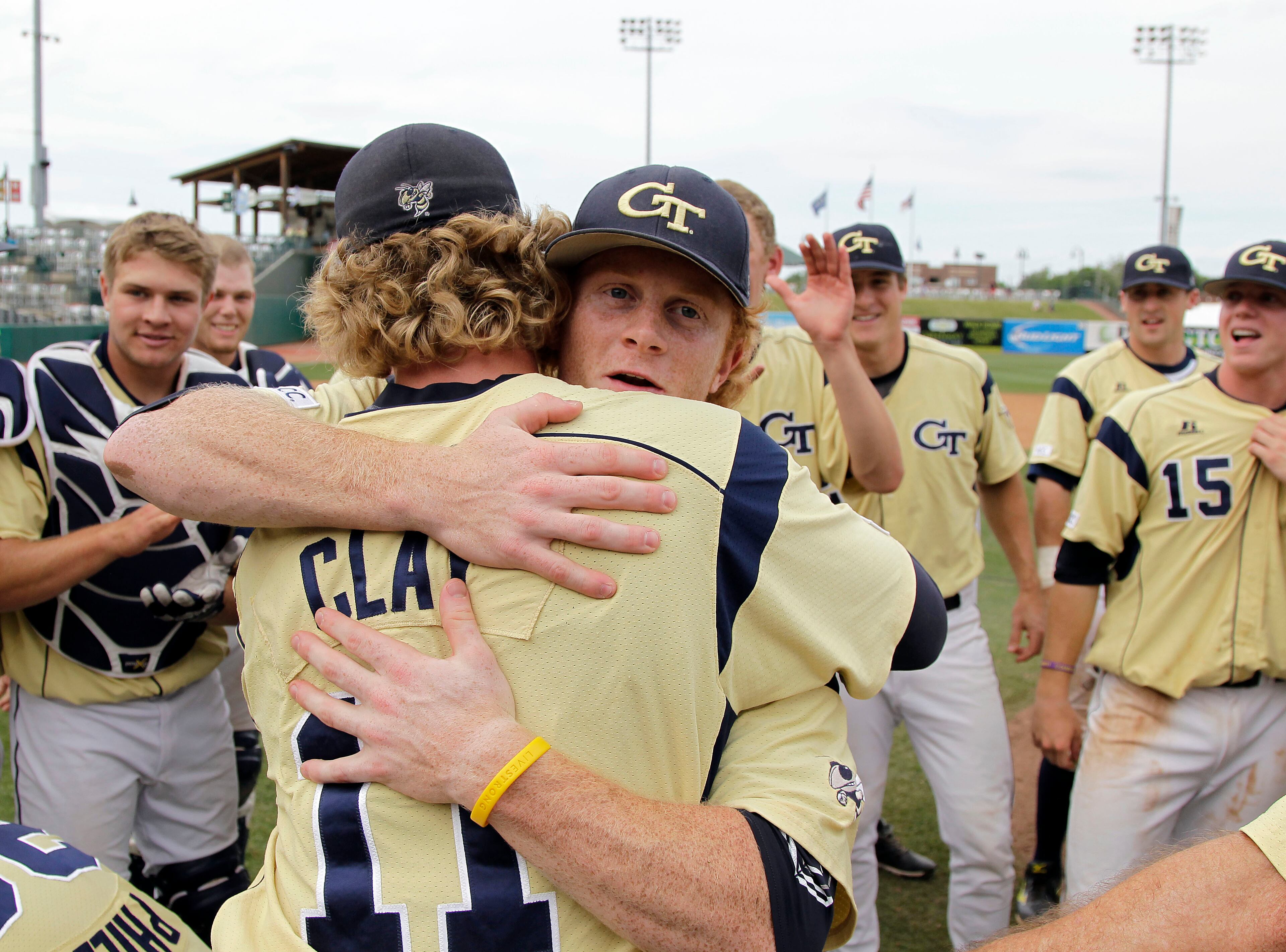 Georgia Tech pitcher Sam Clay gets a hug from teammate Matt Gonzalez as they celebrate their 9-4 win over Maryland to capture the championship game of the Atlantic Coast Conference baseball tournament in Greensboro, N.C., Sunday, May 25, 2014. (AP Photo/Bob Leverone)