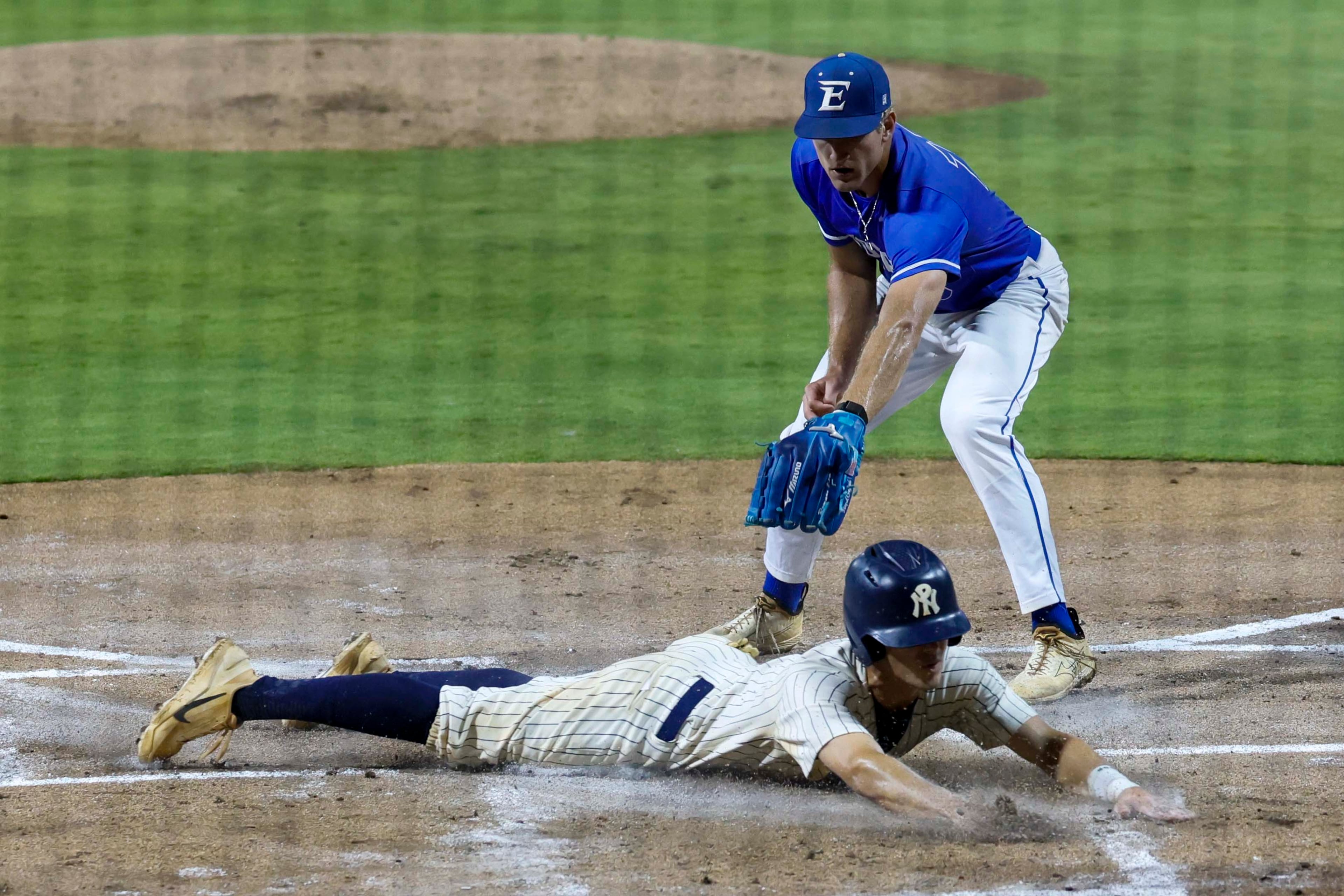 North Paulding Wolfpack utility Wesley Moering scores on a wild pitch from Etowah Eagles pitcher Matthew Sharman during the first inning of Game 1 of the Class 6A GHSA baseball finals at Gwinnett Field on Tuesday, May 26, 2026, in Lawrenceville, Ga. (Miguel Martinez/AJC)