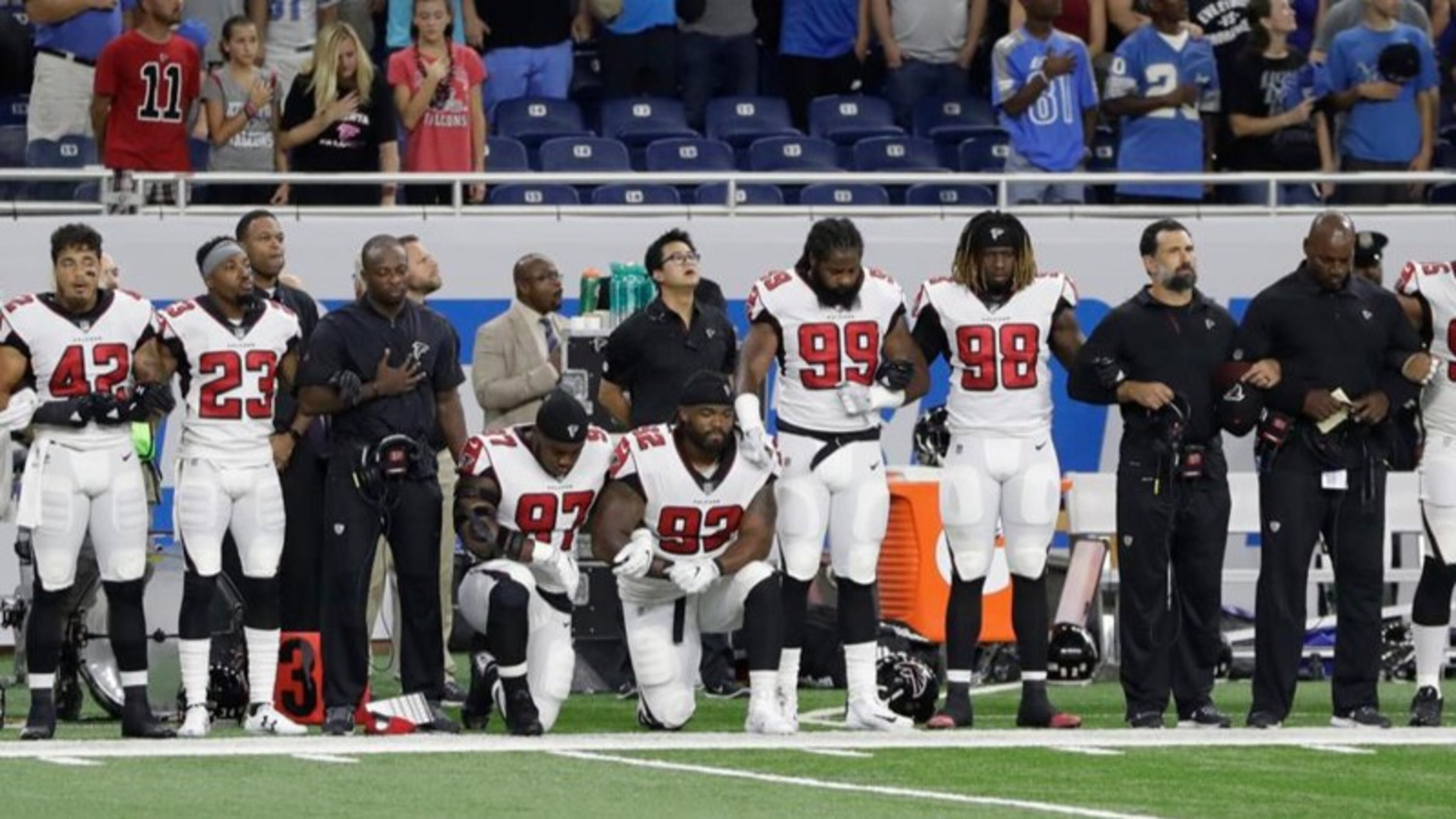 Atlanta Falcons defensive tackles Grady Jarrett (97) and Dontari Poe (92) take a knee during the national anthem before an NFL football game. Carlos Osorio/AP