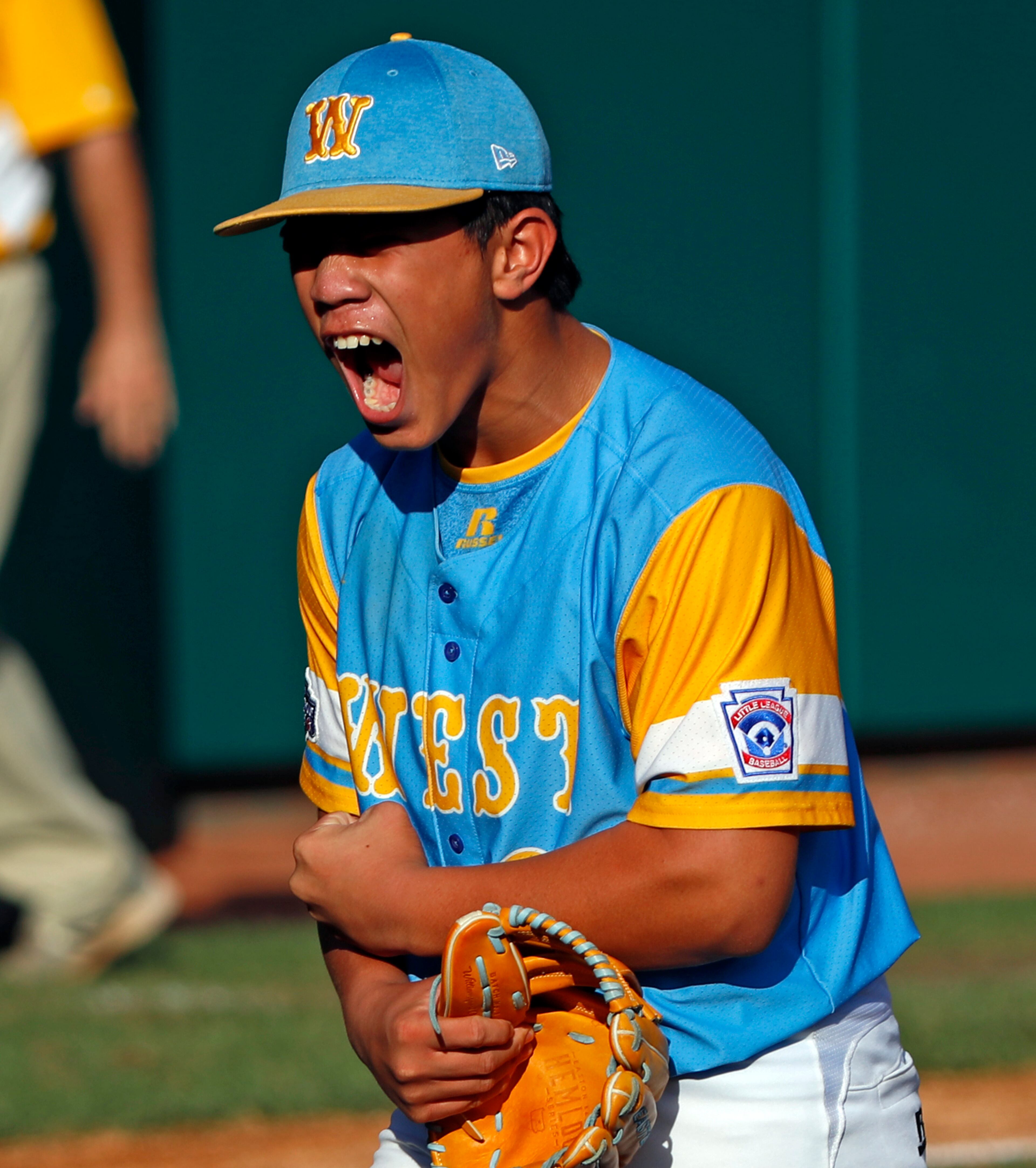 Honolulu, Hawaii's Aukai Kea (23) celebrates getting the final out of the United States Championship baseball game against Peachtree City, Georgia at the Little League World Series tournament in South Williamsport, Pa., Saturday, Aug. 25, 2018. Hawaii won 3-0 and will face South Korea in the Little League World Series Championship game Sunday. (AP Photo/Tom E. Puskar)