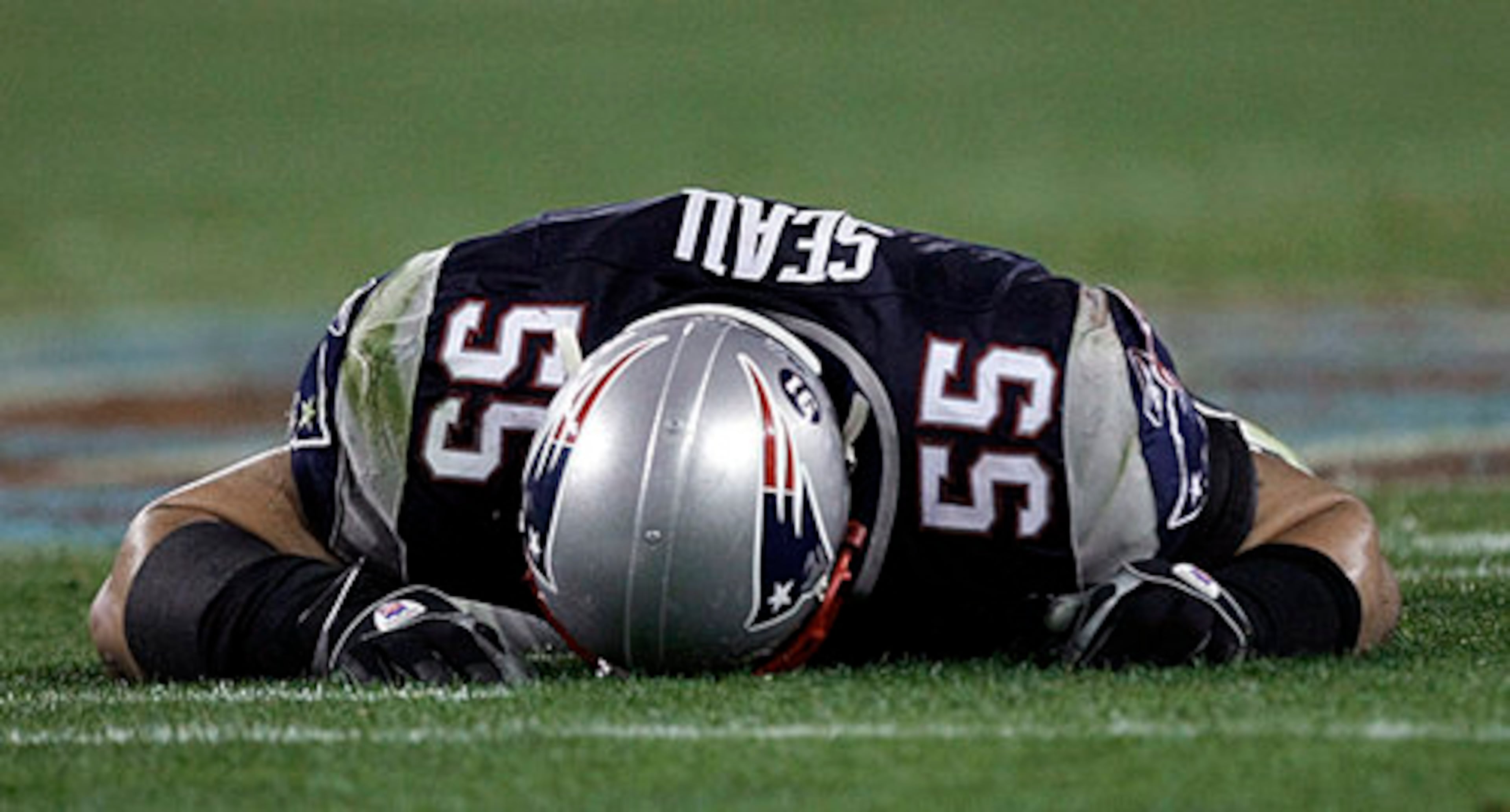 Seau lies on the turf after New York Giants receiver Plaxico Burress scored a touchdown in the fourth quarter of the Super Bowl XLII football game on Sunday, Feb. 3, 2008, in Glendale, Ariz.