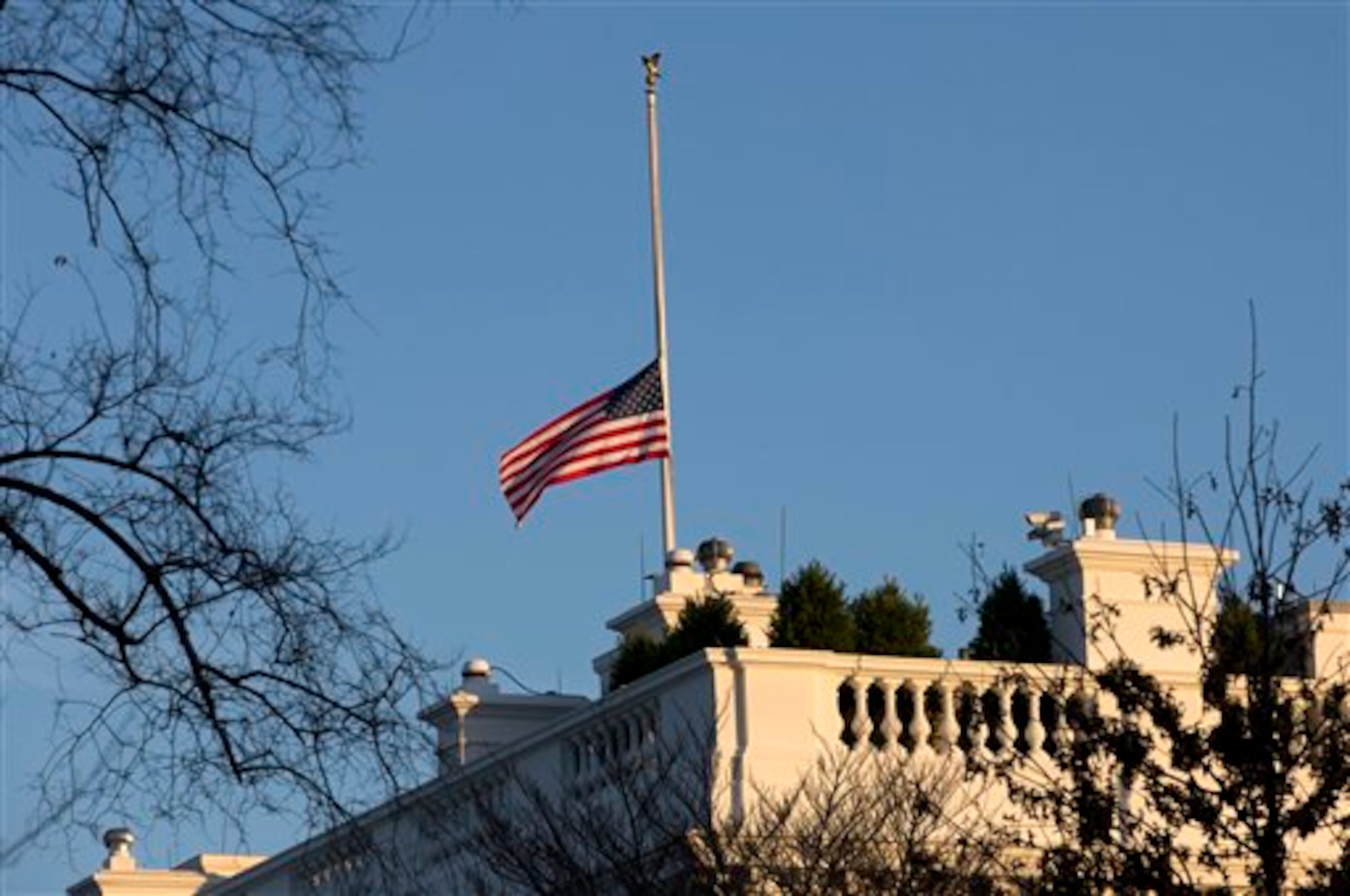 An American flag flies at half-staff over the White House in Washington, Friday, Dec. 14, 2012, in honor of the Connecticut elementary school shooting victims. (AP Photo/Charles Dharapak)