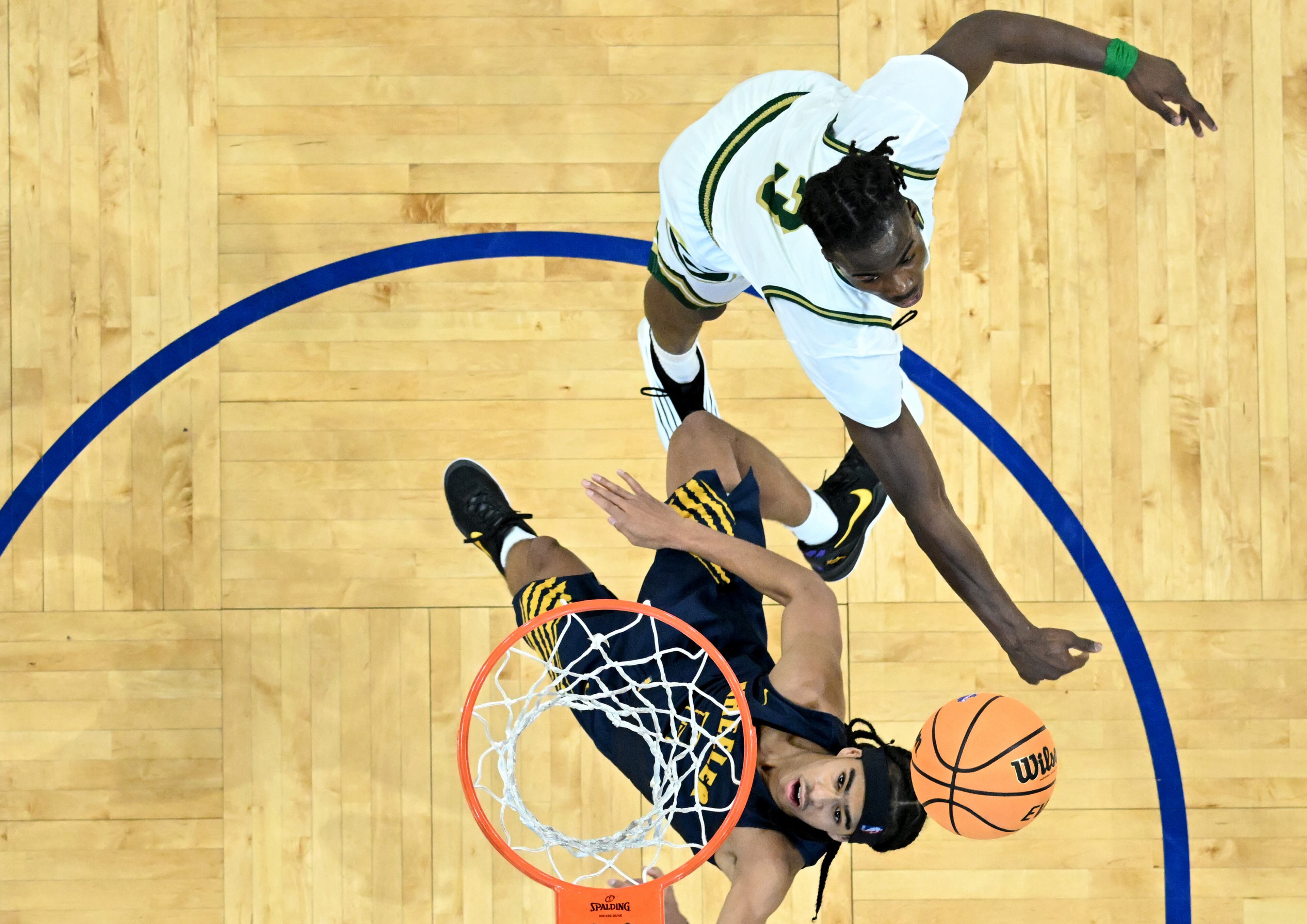 Wheeler's Kevin Savage (2) goes to the basket for the shot past Grayson's Caleb Holt (3) during the second half of the GHSA Class 6A Boys State Basketball playoffs game at the Georgia State Convocation Center, Saturday, March 1, 2025, in Atlanta. Wheeler won 68-53 over Grayson. (Hyosub Shin / AJC)