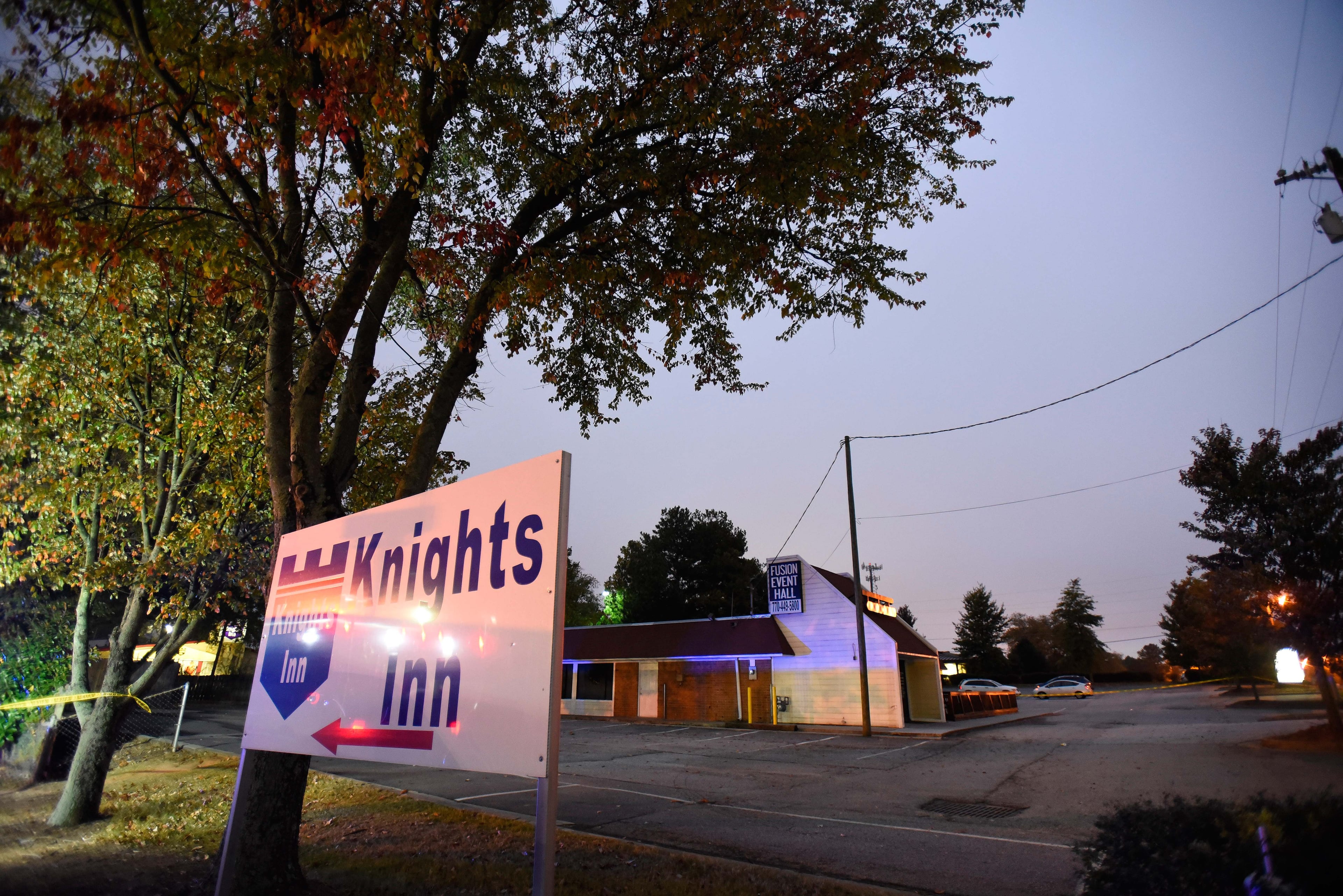 Norcross police and the GBI investigate an officer-involved shooting at the Fusion Event Hall parking lot next to a Knights Inn motel and the adjacent Waffle House at Indian Trail Road and Brook Hollow Parkway on Monday, Oct. 13, 2014, in Norcross, Ga.