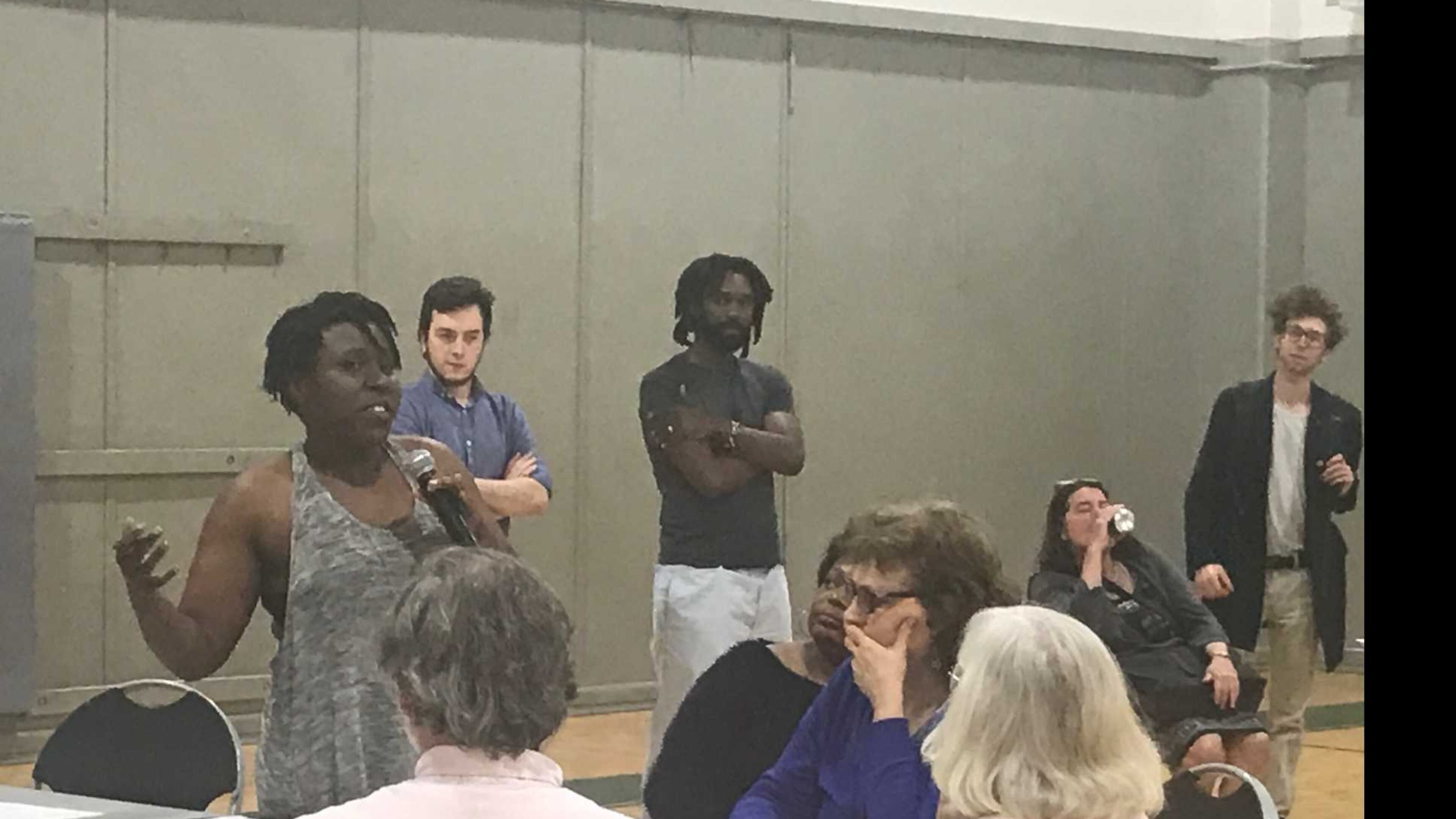 University of Georgia graduate student Rachelle Berry, holding the microphone, discussed ways they can pressure university administrators to address some of their issues with the school. ERIC STIRGUS / ESTIRGUS@AJC.COM.