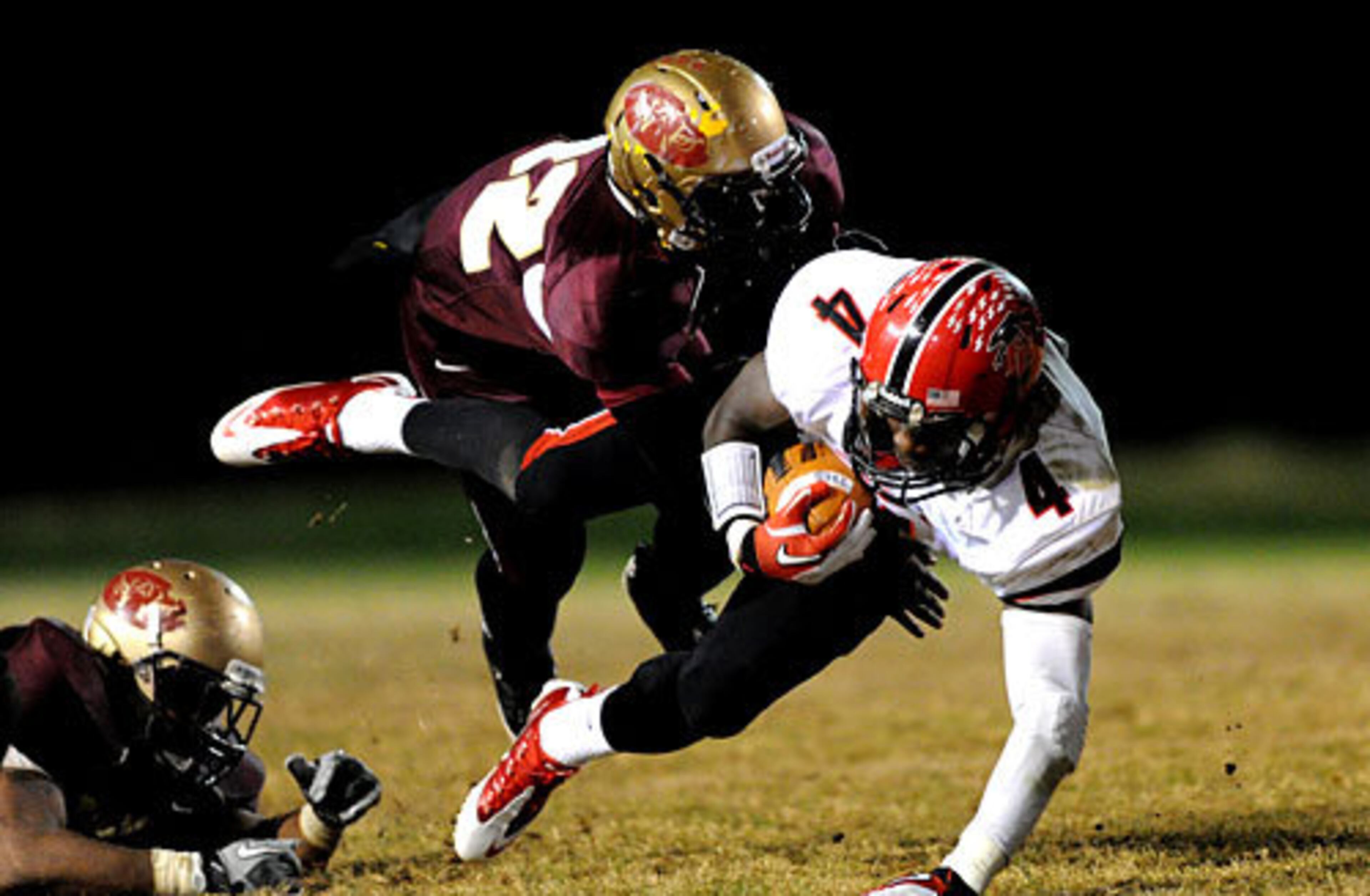 Flowery Branch's C.J. Curry (4) is tackled by Tucker's Blair Lampkin.