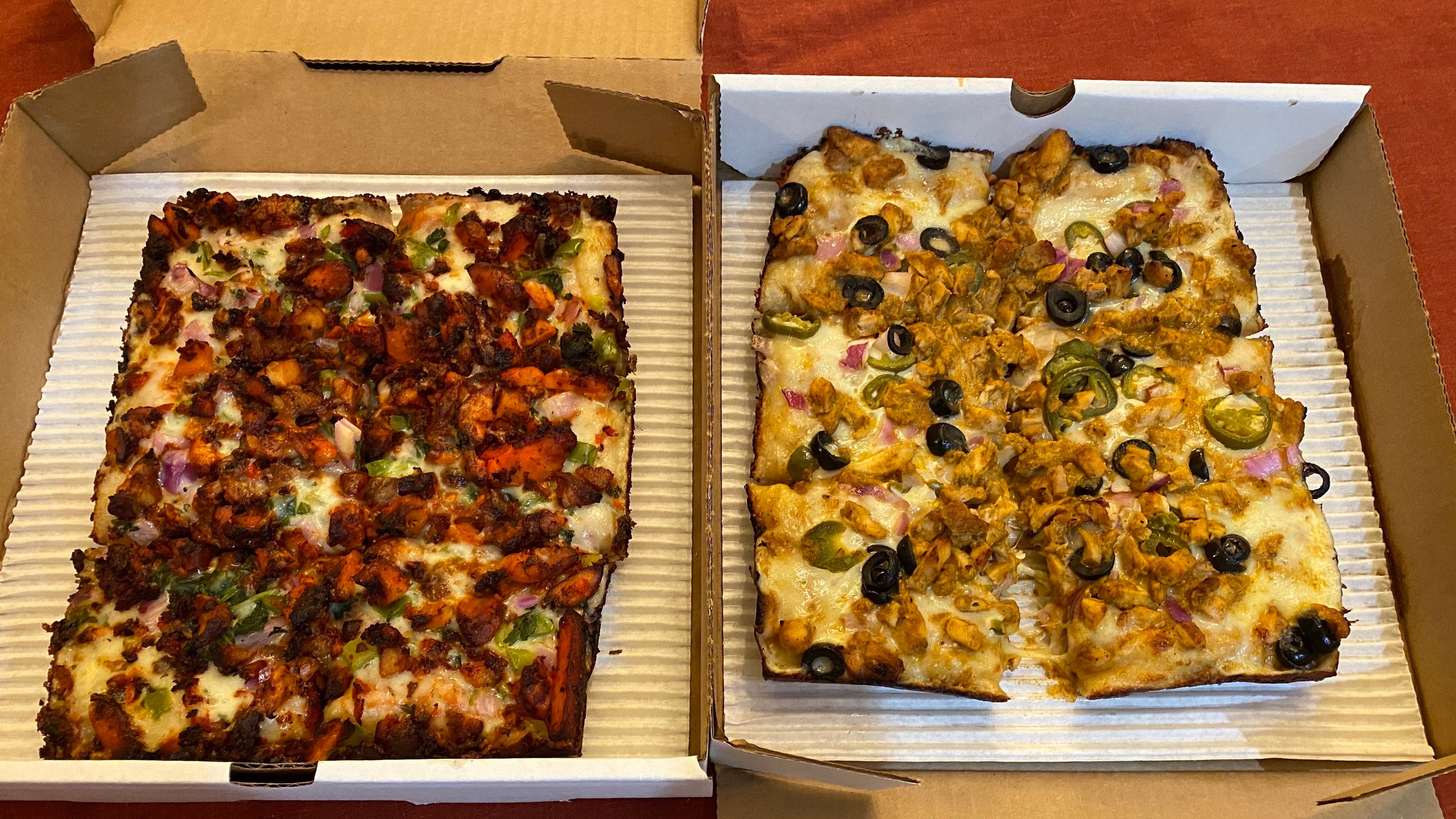 Rice N' Pie offers Detroit-style pizzas with Indian toppings, including the spicy 65 (left) and milder Butter Chicken (right).
Ligaya Figueras / ligaya.figueras@ajc.com