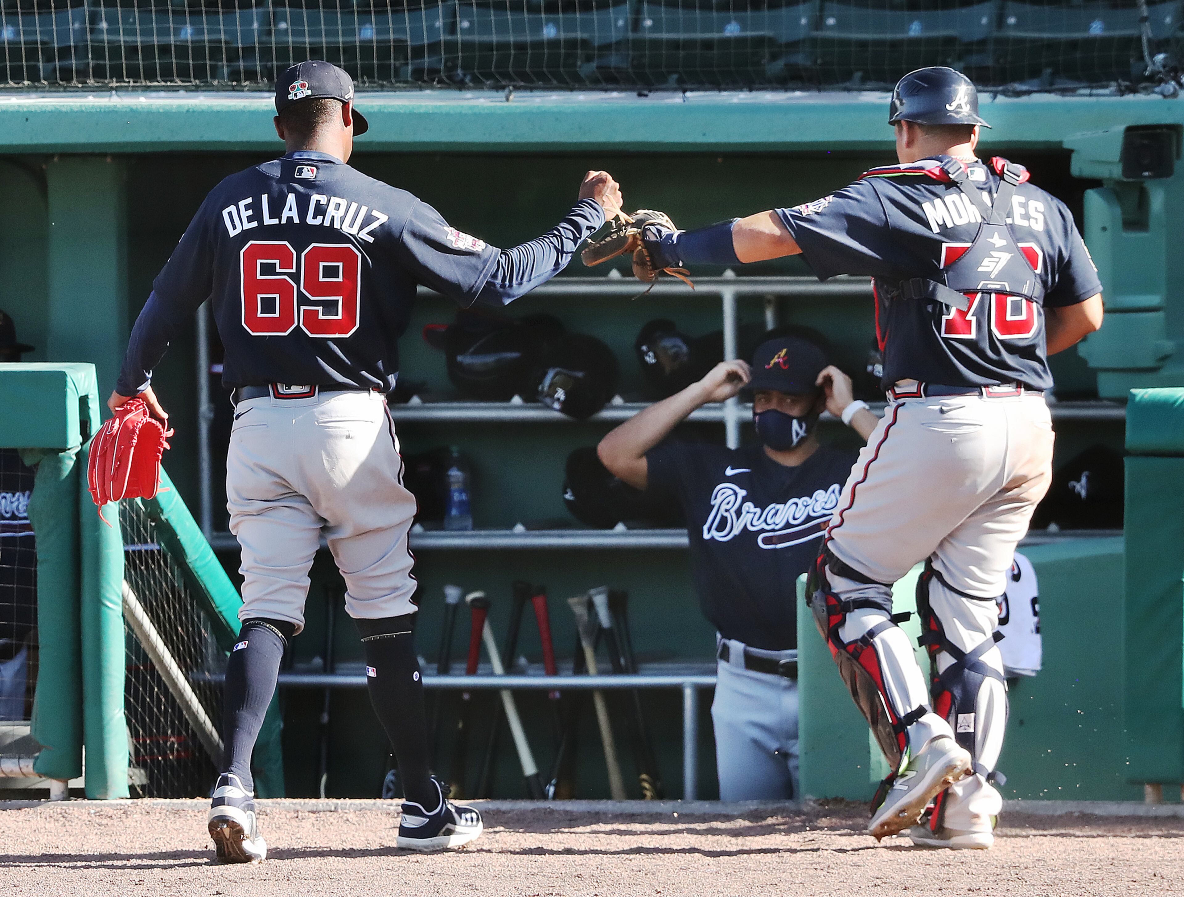 Atlanta Braves pitcher Jasseel De La Cruz fist-bumps catcher Jonathan Morales after closing out the 5-2 win over the Boston Red Sox in the seventh inning Monday, March 1, 2021, at JetBlue Park in Fort Myers, Fla. (Curtis Compton / Curtis.Compton@ajc.com)