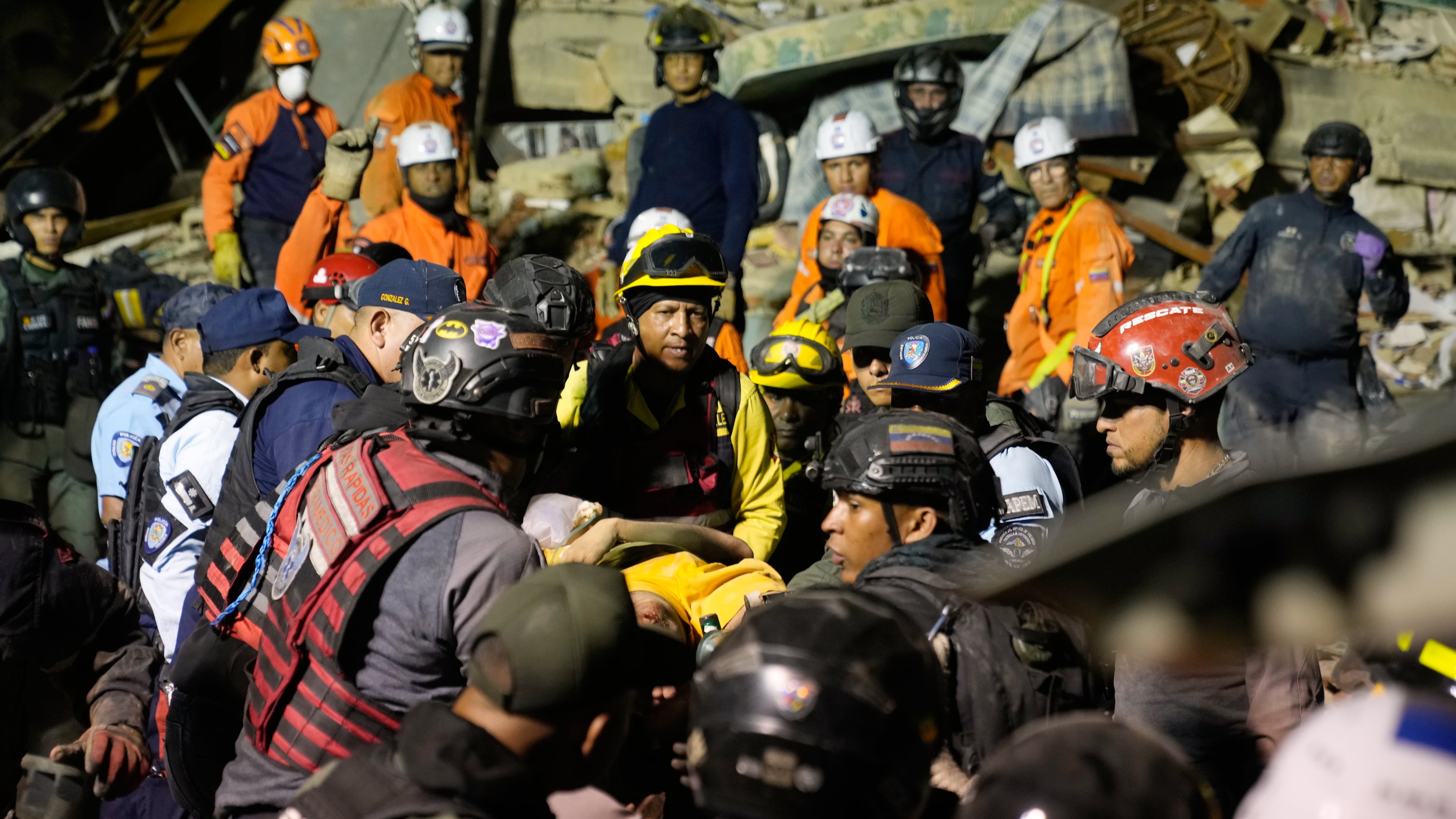 Rescue workers search through the rubble of a collapsed building after earthquake in Caracas, Venezuela, Wednesday, June 24, 2026. (AP Photo/Ariana Cubillos)