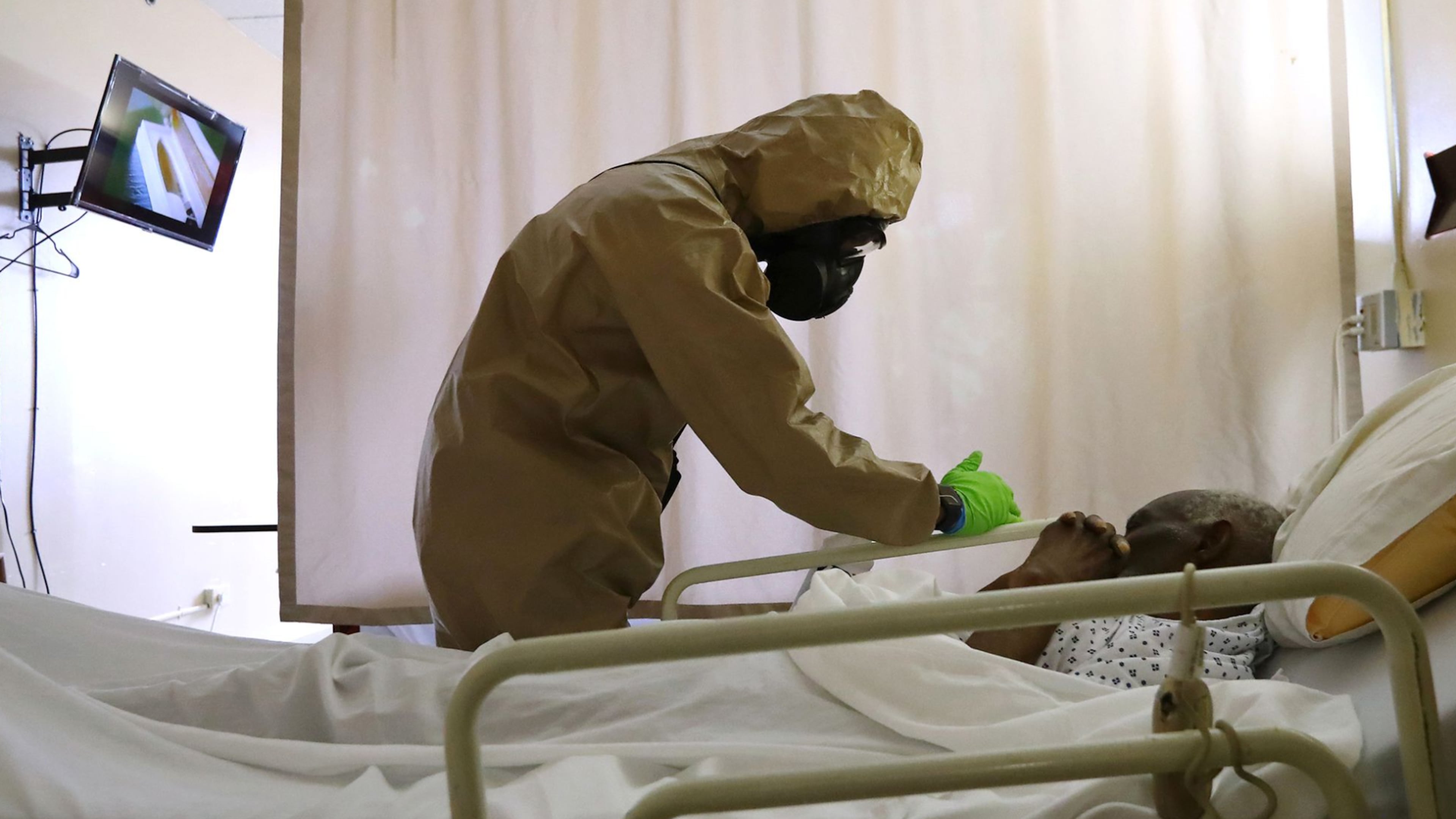 A member of the Georgia Army National Guard infection control team from the 265th Chemical Battalion compassionately cleans the bed railings of a resident without waking him at Legacy Transitional Care while disinfecting the room where COVID-19 has taken its toll on April 19, 2020, in Atlanta. Curtis Compton ccompton@ajc.com