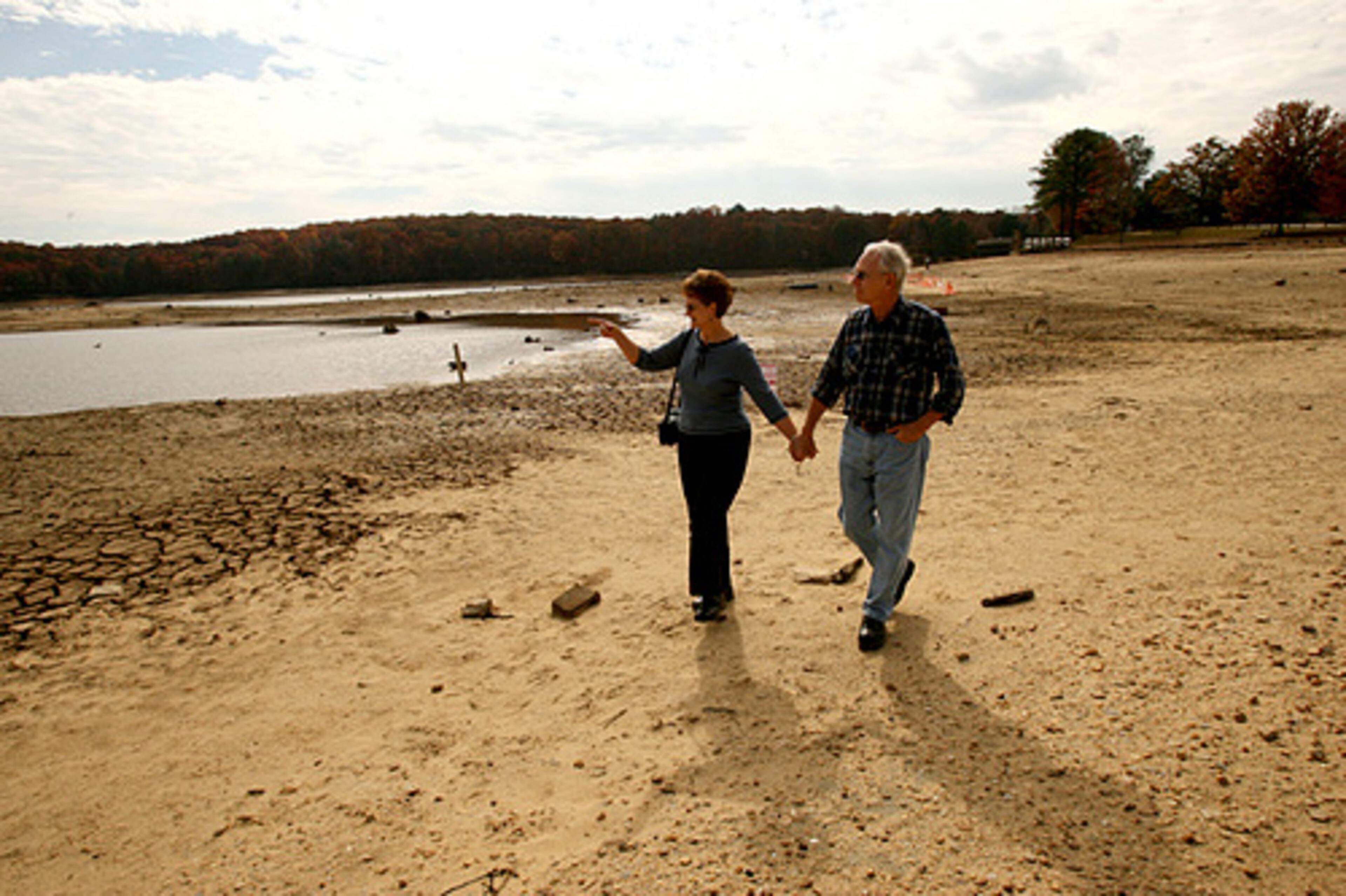 Mal and Lin Rabern walk on dry land through the the George Sparks Reservoir.