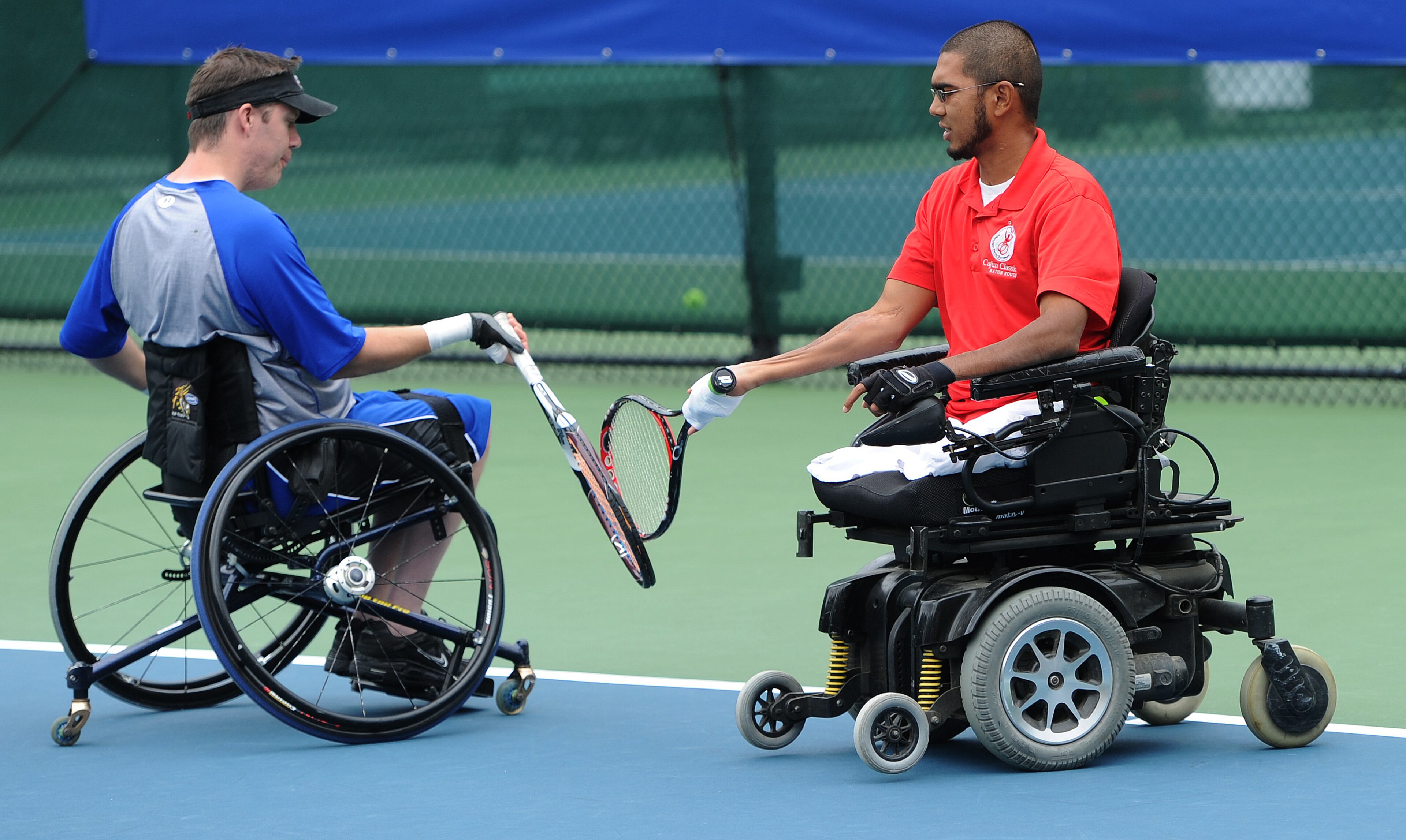 Baxter,USA, and M. Shoeb Khan,USA, touch rackets after scoring a point during the Atlanta Open Wheelchair Tennis Championships at the Dunwoody Country Club on Wednesday, May 1, 2013. They lost the match. JOHNNY CRAWFORD / JCRAWFORD@AJC.COM