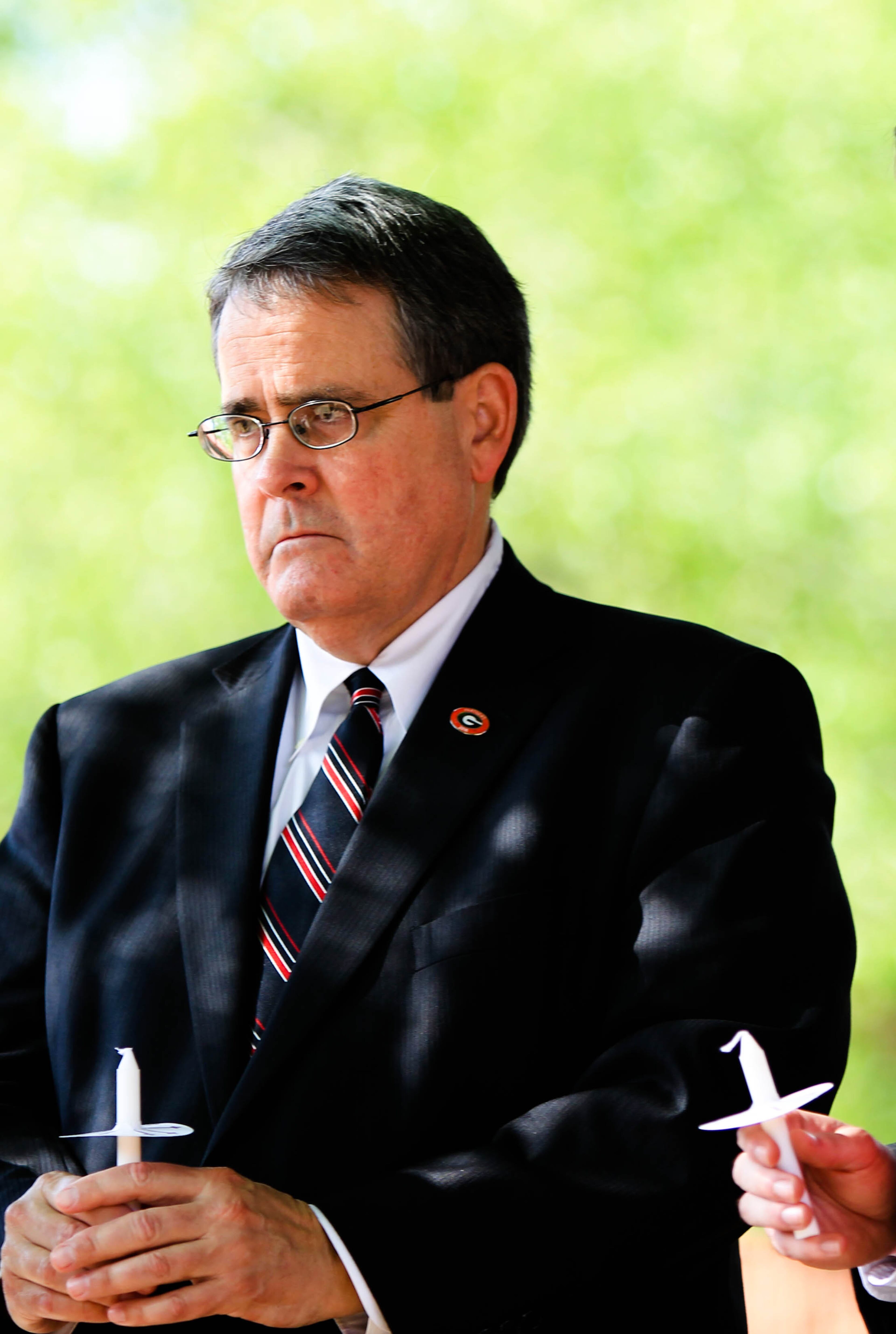 University of Georgia President Jere Morehead hold a candle during the vigil to honor four students who lost their lives in a car accident late Wednesday night. A fifth student was in critical condition. TAYLOR CARPENTER / TAYLOR.CARPENTER@AJC.COM