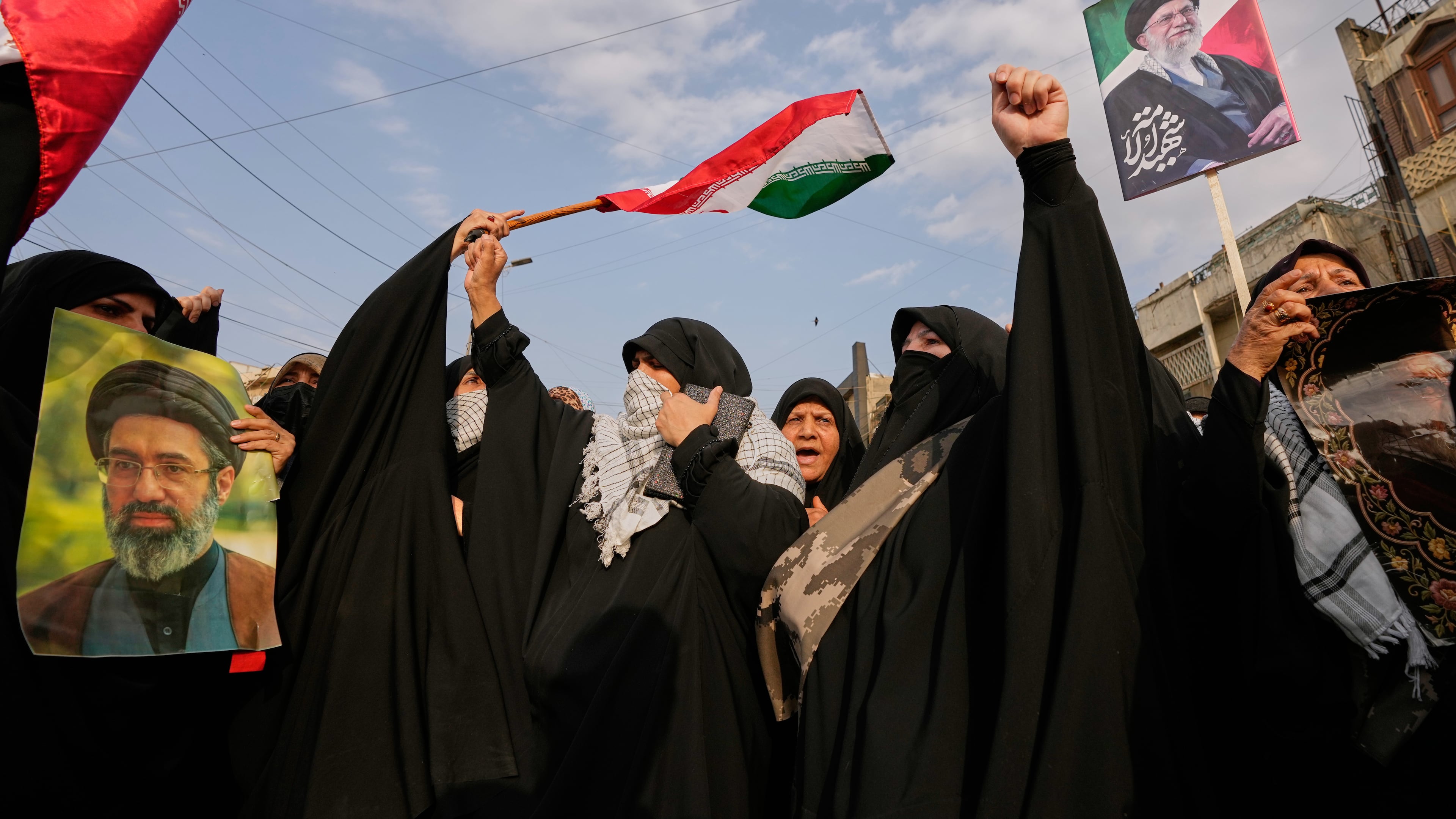 Iraqi Muslim women hold portraits of Iran's late Supreme Leader Ayatollah Ali Khamenei and his son Ayatollah Mojtaba Khamenei, during a protest against U.S. and Israeli attacks on multiple cities across Iran, in Baghdad, Iraq, Saturday, April 25, 2026. (AP Photo/Hadi Mizban)