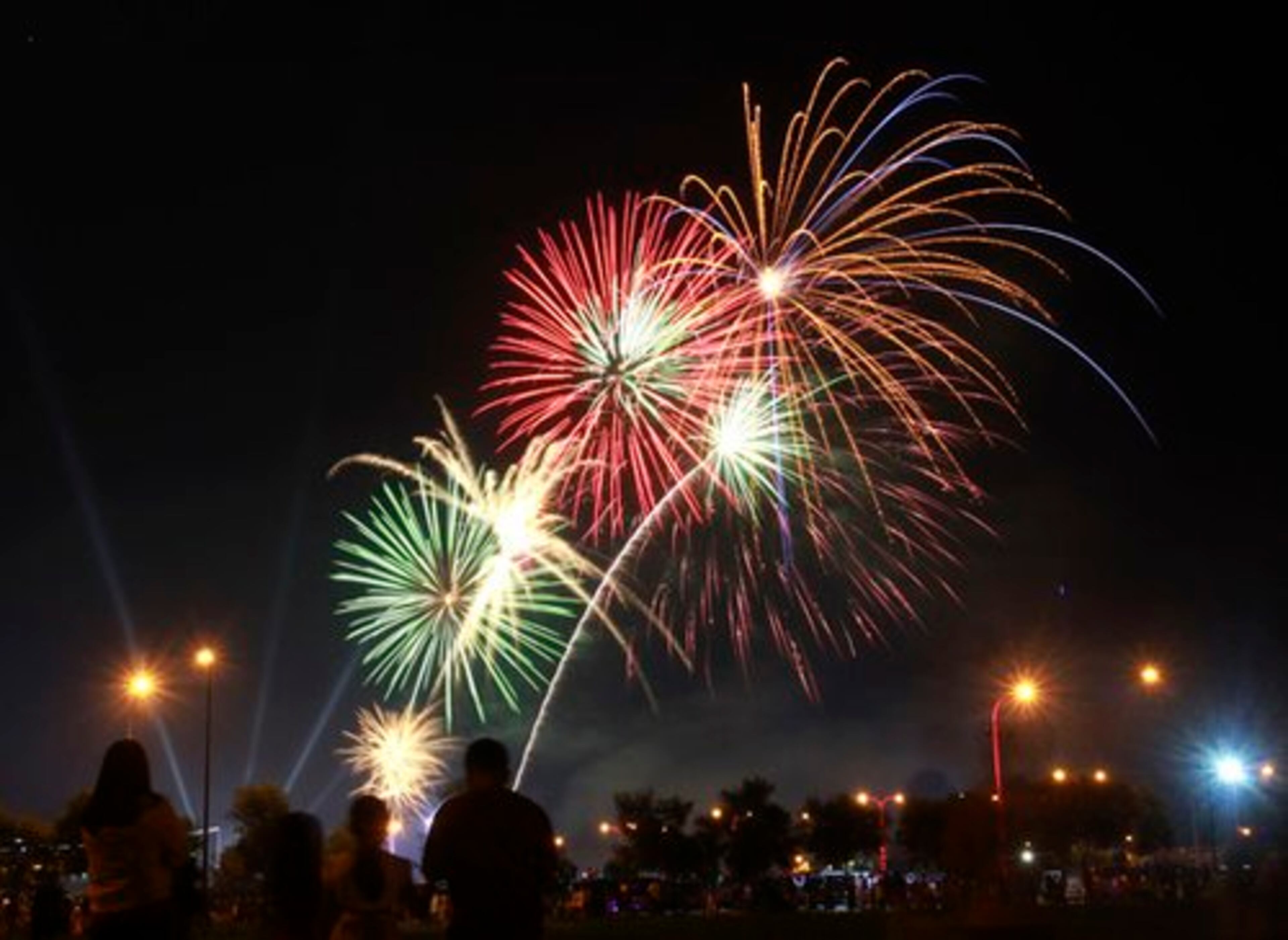 Revelers watch fireworks light up the sky to welcome in the New Year in Manila, Philippines.
