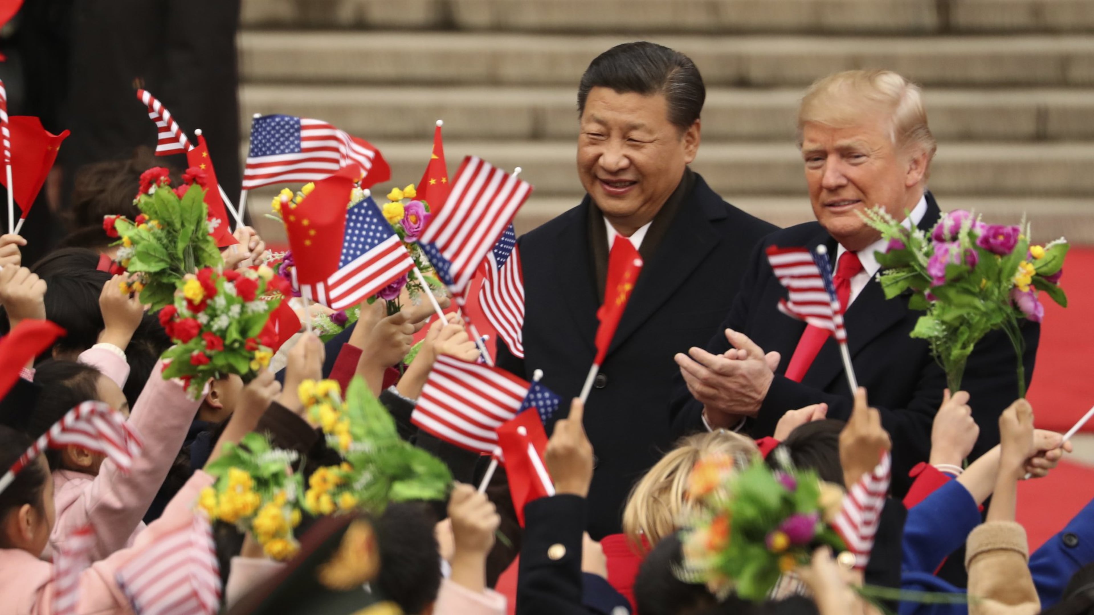 FILE - In this Nov. 9, 2017, file photo, President Donald Trump and Chinese President Xi Jinping participate in a welcome ceremony at the Great Hall of the People in Beijing, China. Trump couldn’t seem to stop talking about the red carpets, military parades and fancy dinners that were lavished upon him during “state visits” on his recent tour of Asia. “Magnificent,” he declared at one point on the trip. But Trump has yet to reciprocate in kind. In fact, he is the first president in decades to close his first year in office without welcoming a counterpart on a visit to the U.S. with similar trappings. (AP Photo/Andrew Harnik, File)