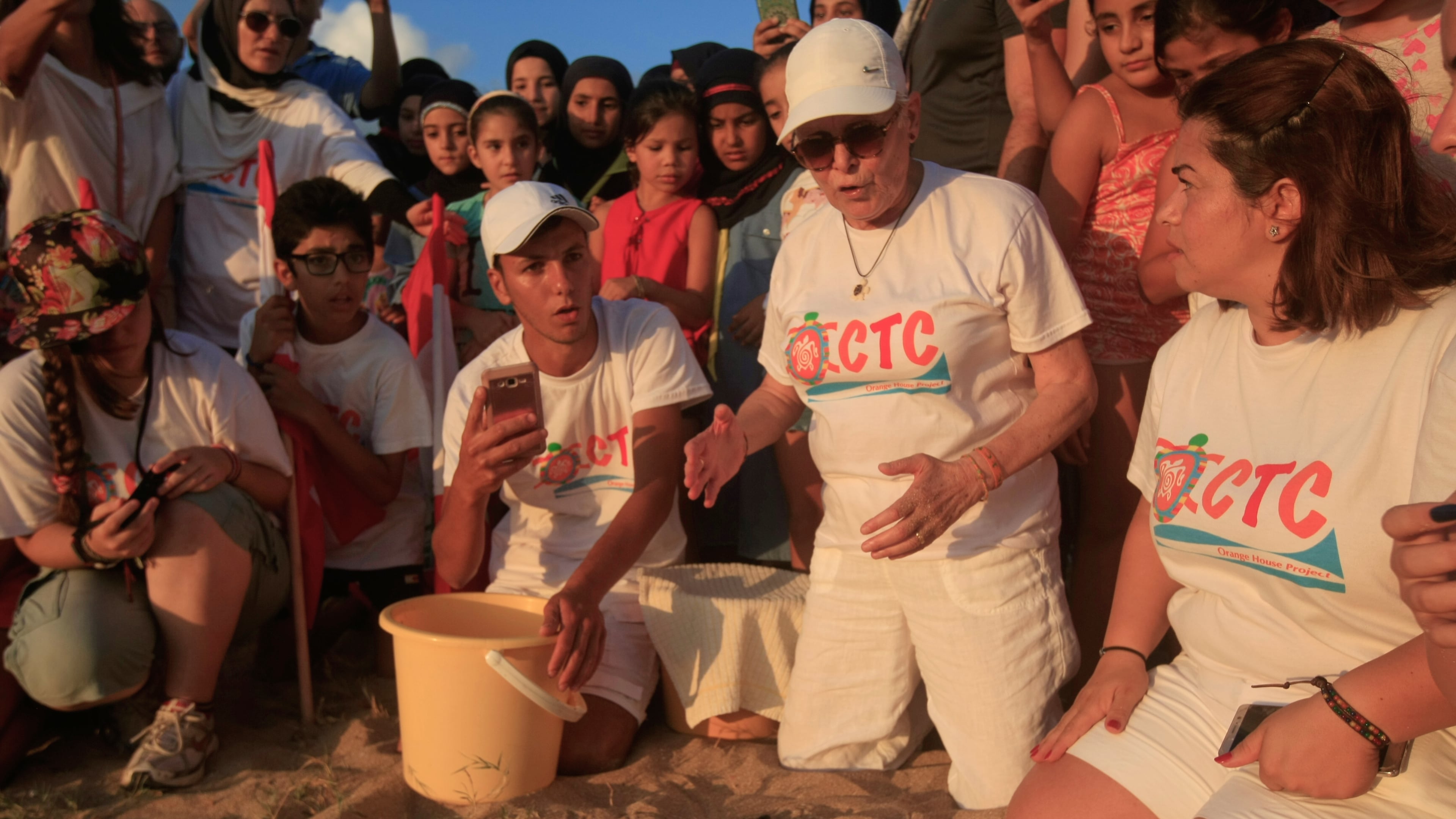 Mona Khalil, a Lebanese conservationist who died on Friday after being wounded in an Israeli strike on her home on Lebanon's southern coast, releases baby sea turtles in Mansouri village near Tyre city, south Lebanon, July 29, 2018. (AP Photo/Hussein Malla)