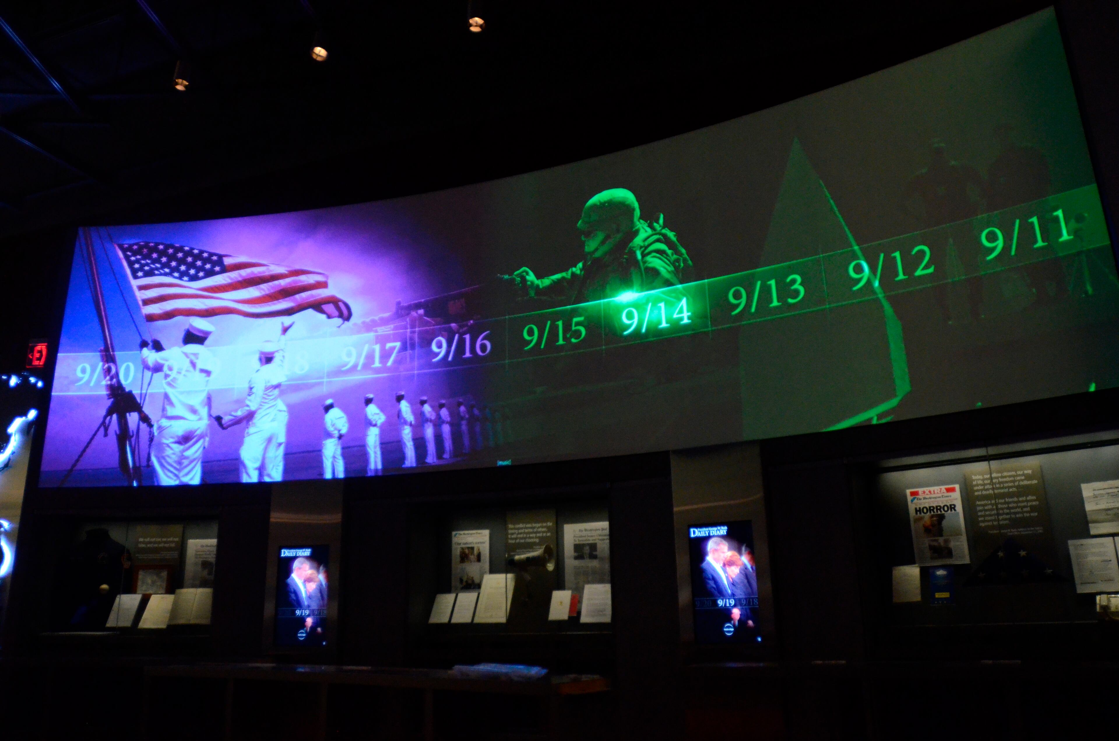 In this photo taken April 16, 2013, a large screen displays images and video of the events and days that followed the 9/11 terrorist attacks as part of an exhibit in the museum area at the George W. Bush Presidential Library and Museum in Dallas. The museum uses everything from news clips to interactive screens to artifacts to tell the story of Bush's eight years in office. The George W. Bush Presidential Center, which includes the library and museum along with 43rd president's policy institute, will be dedicated Thursday on the campus of Southern Methodist University in Dallas. (AP Photo/Benny Snyder)