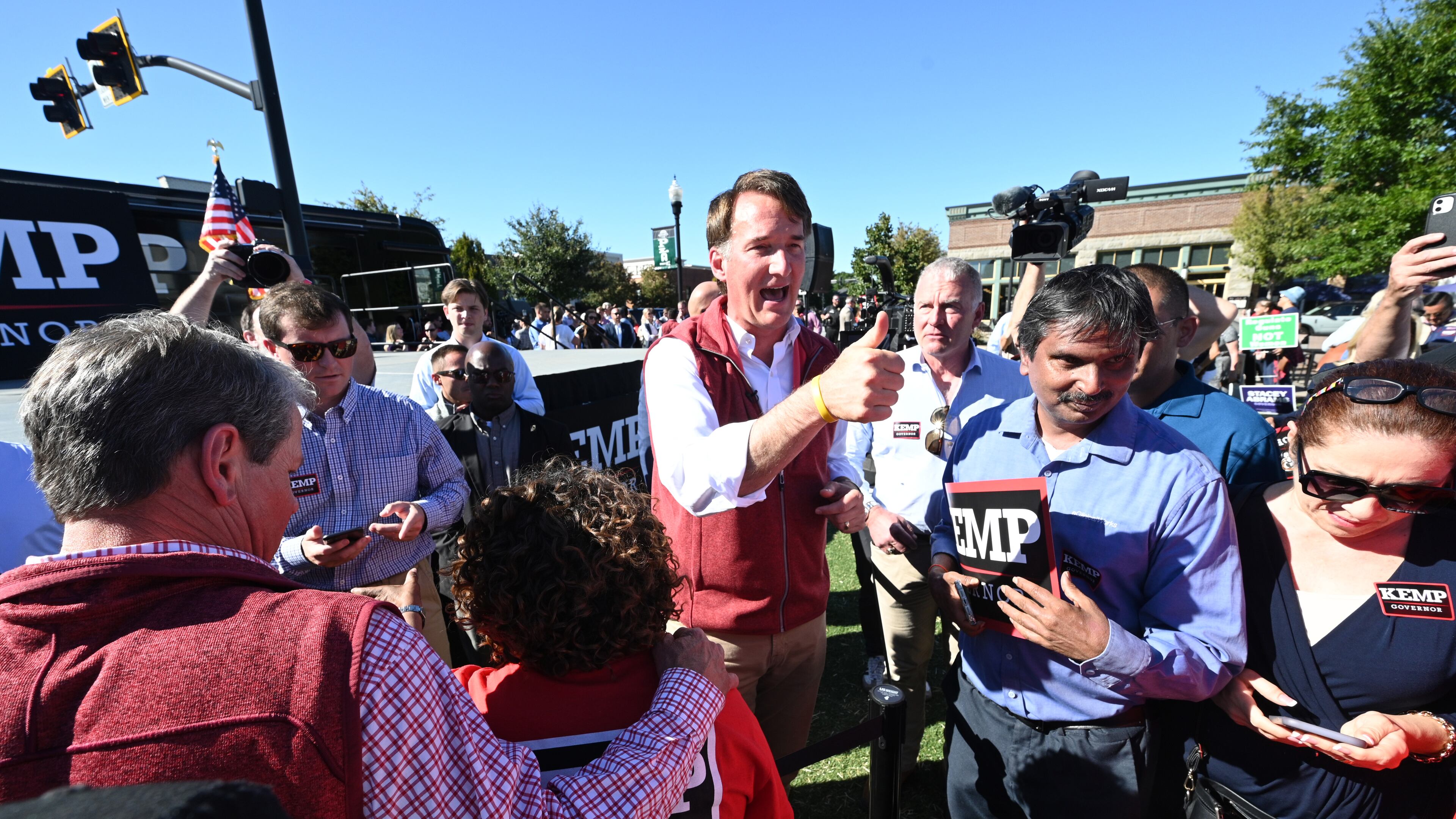 September 27, 2022 Alpharetta - Georgia Governor Brian Kemp (left) and Virginia Governor Glenn Youngkin greet supporters during a Get Out the Vote Rally for at Town Green Fountain in Alpharetta on Tuesday, September 27, 2022. (Hyosub Shin / Hyosub.Shin@ajc.com)