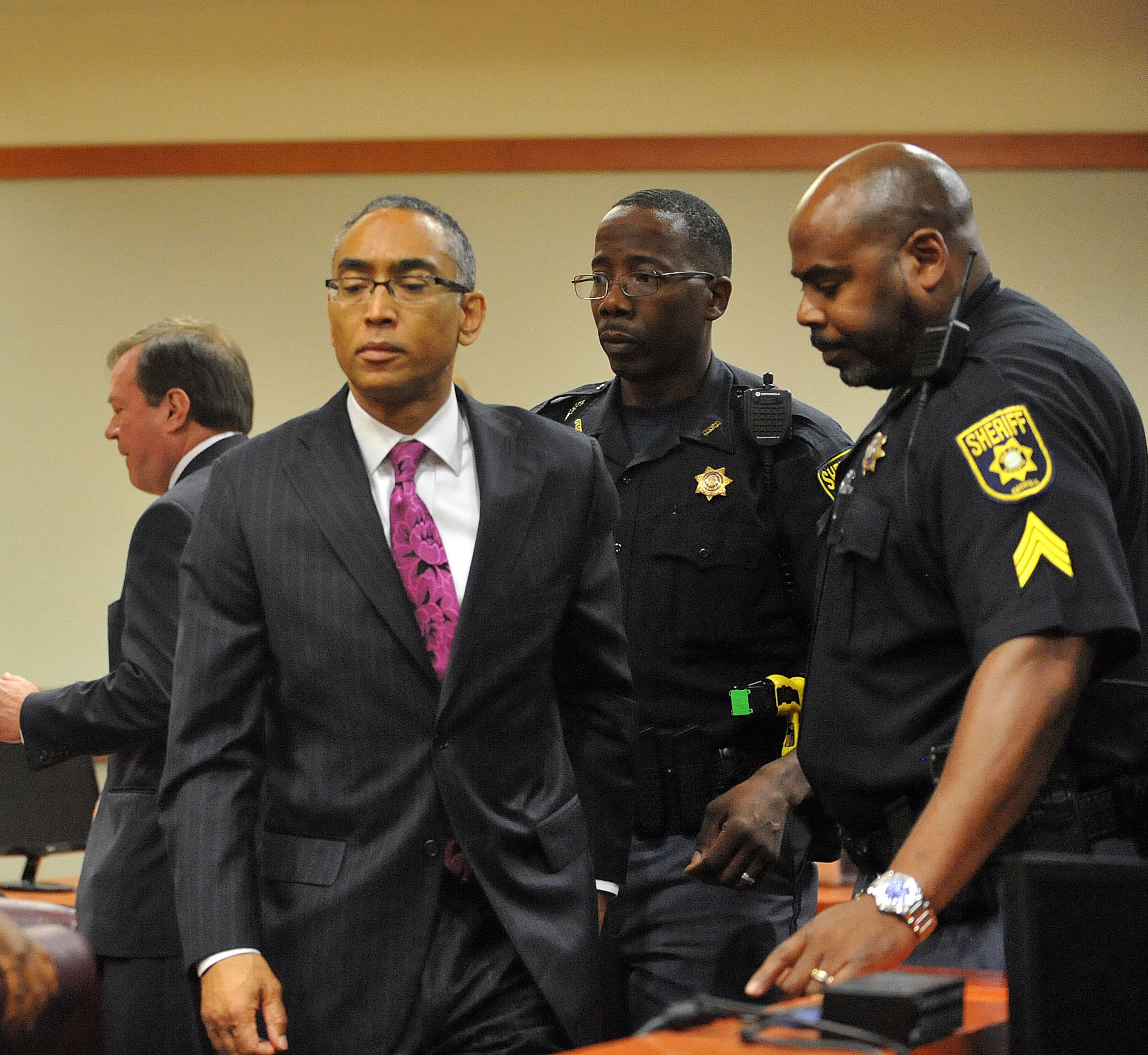 Embattled DeKalb County CEO Burrell Ellis is led out after he was sentenced to 5 years to serve 18 months in prison Wednesday July 8, 2015. Ellis was found guilty of attempted extortion and perjury a week ago in his retrial before Superior Court Judge Courtney Johnson. But on November 30, 2016, the Georgia Supreme Court unanimously threw out the conviction, ruling that Ellis was denied a fair trial.