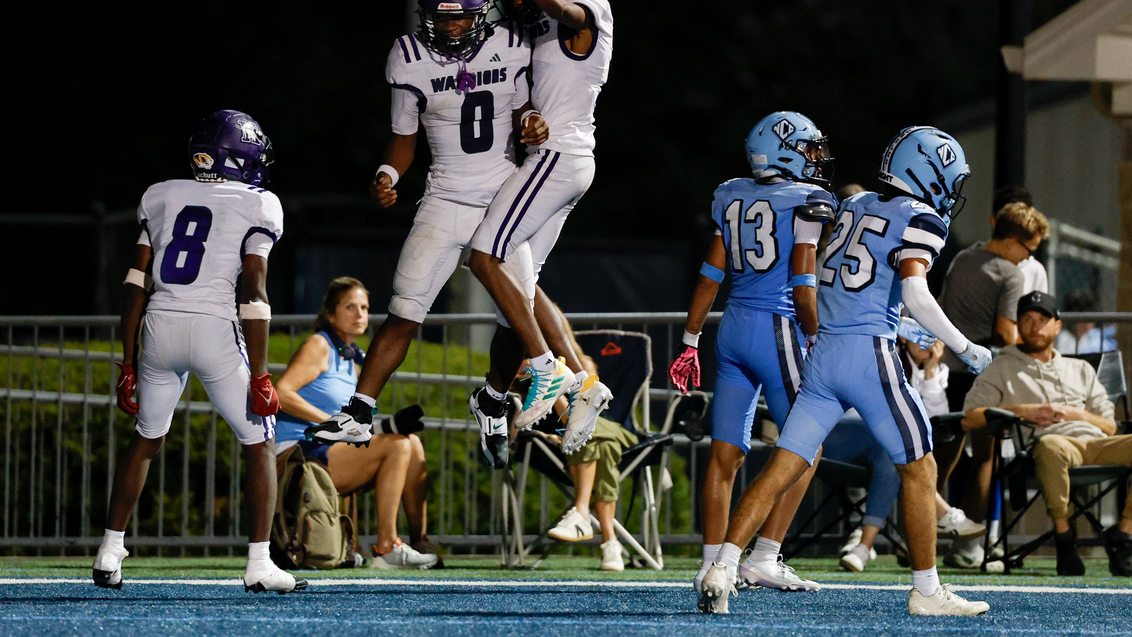 KIPP Atlanta's Dylan Favors (0) celebrates his touchdown with teammates Vincent Lawrence (8) and Tyree Harris (7) during the second half a game between KIPP Atlanta and North Cobb Christian. KIPP Atlanta won 48-17. (Erik S. Lesser for the AJC)